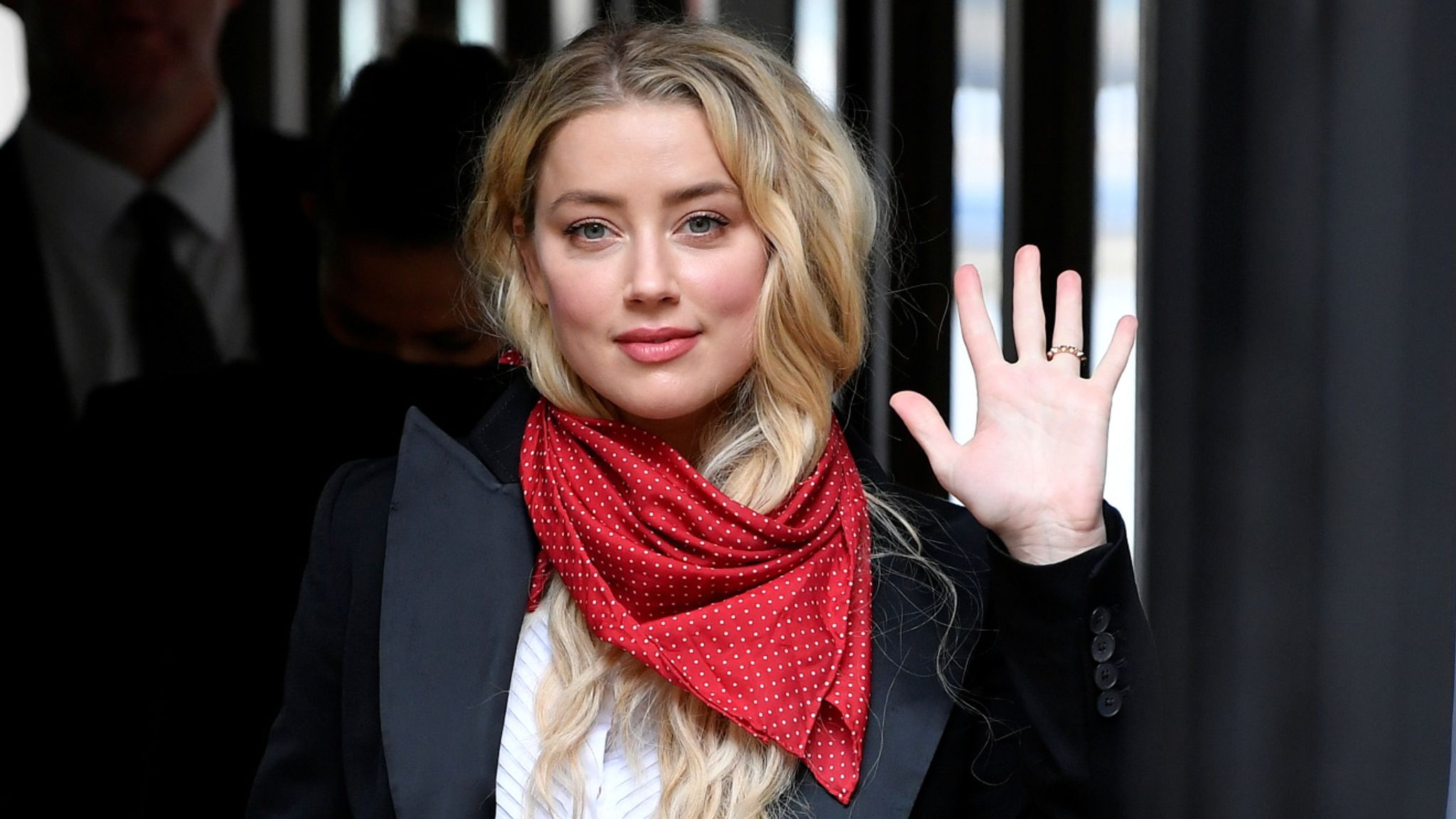 Actor Amber Heard waves as she arrives at the High Court in London, Britain July 14, 2020. REUTERS/Toby Melville