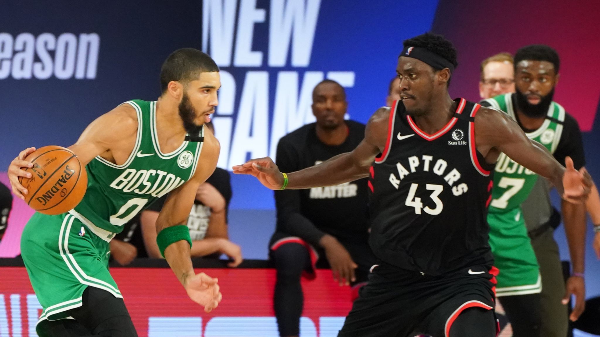 Jayson Tatum of the Boston Celtics handles the ball against Pascal Siakam of the Toronto Raptors during Round Two, Game Six of the Eastern Conference Semifinals