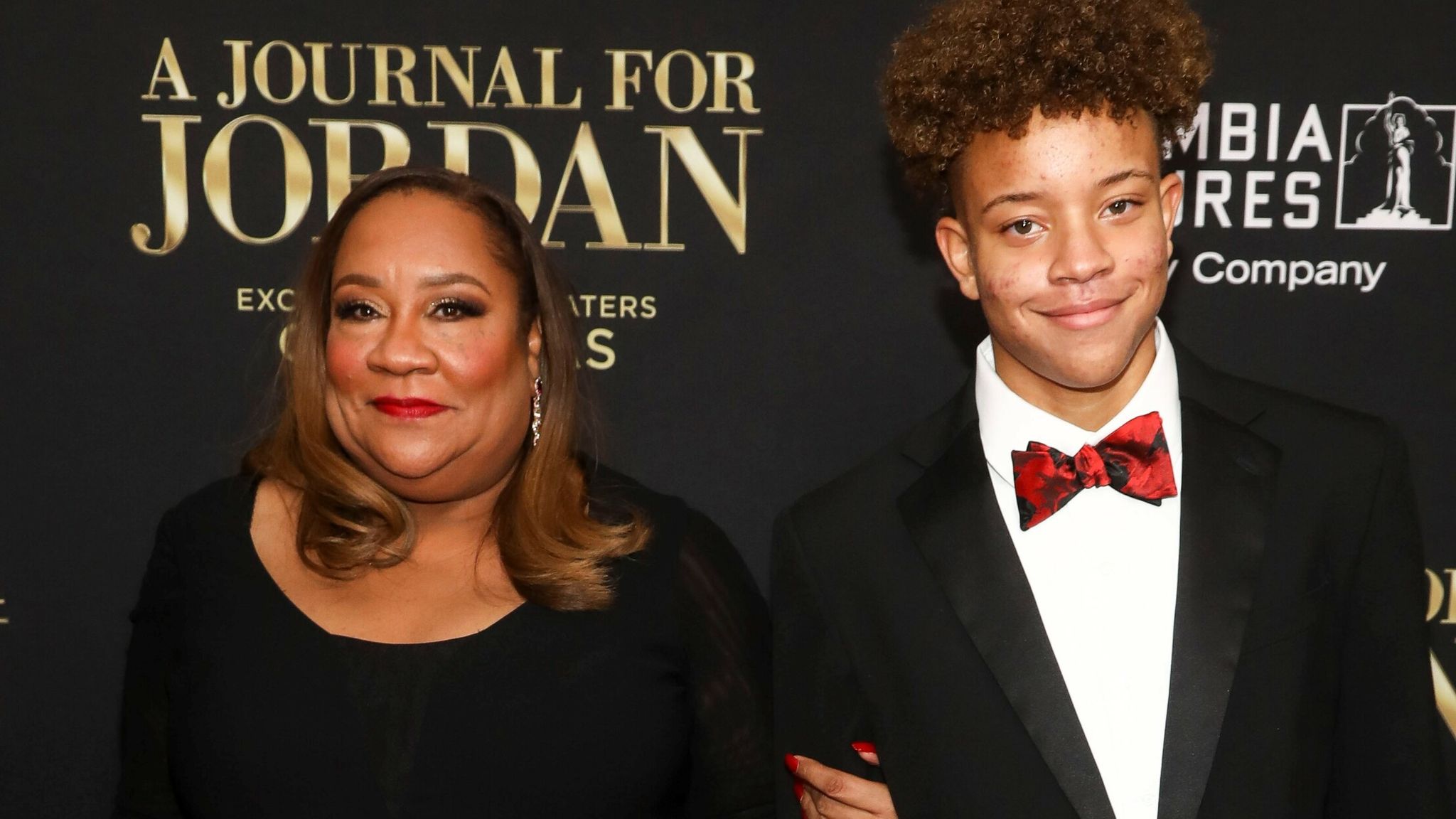 Author Dana Canedy, left, and her son Jordan Canedy at the premiere of A Journal For Jordan in New York in December 2021. Pic: Andy Kropa/Invision/AP