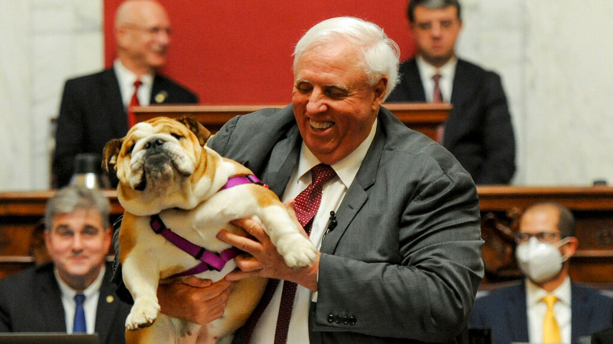 Jim Justice, left, poses with his dog Babydog, right