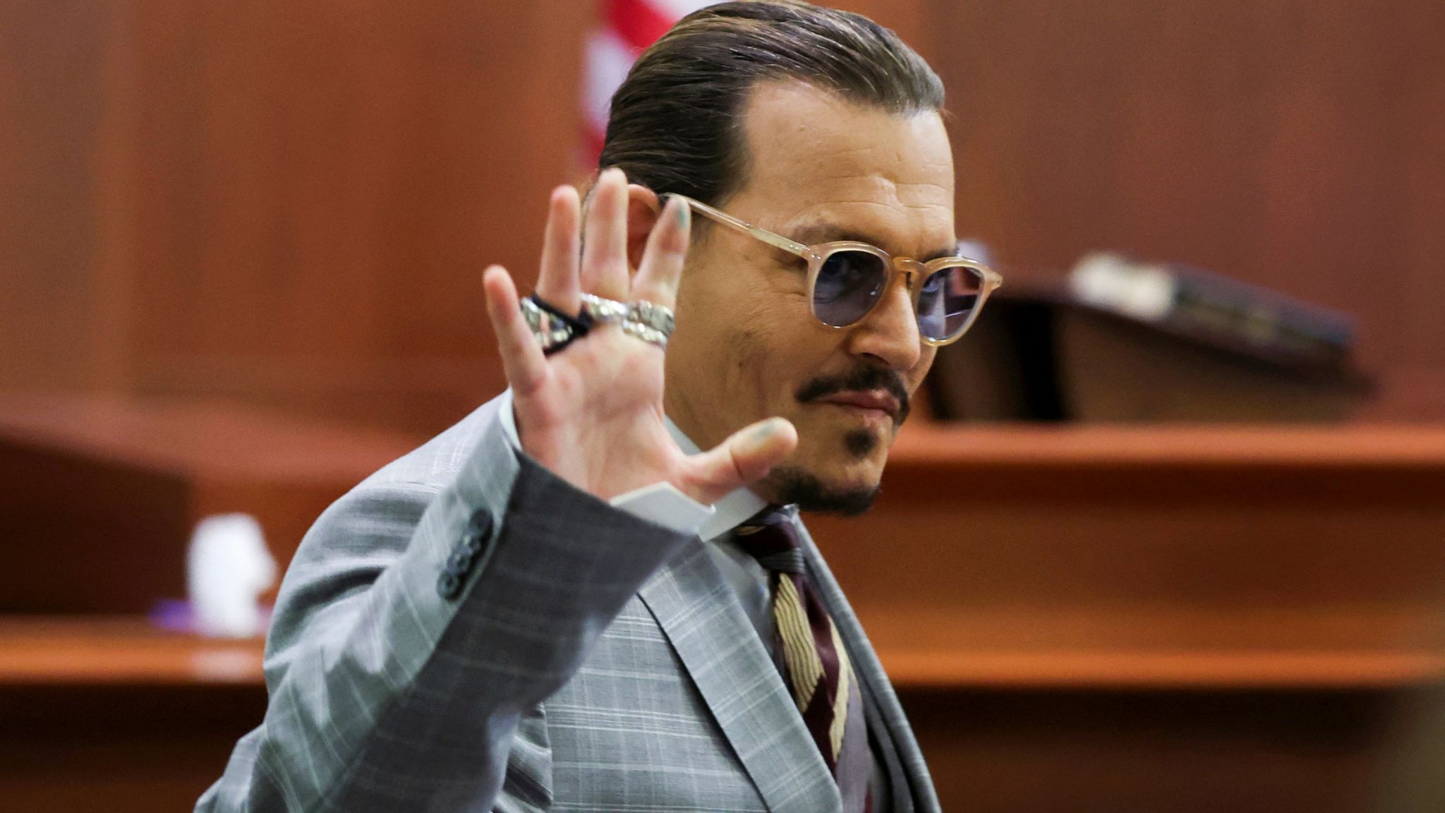 Actor Johnny Depp reacts as he leaves for a break during the Depp vs Heard defamation trial at the Fairfax County Circuit Court in Fairfax, Virginia, U.S. May 26, 2022. Michael Reynolds/Pool via REUTERS 