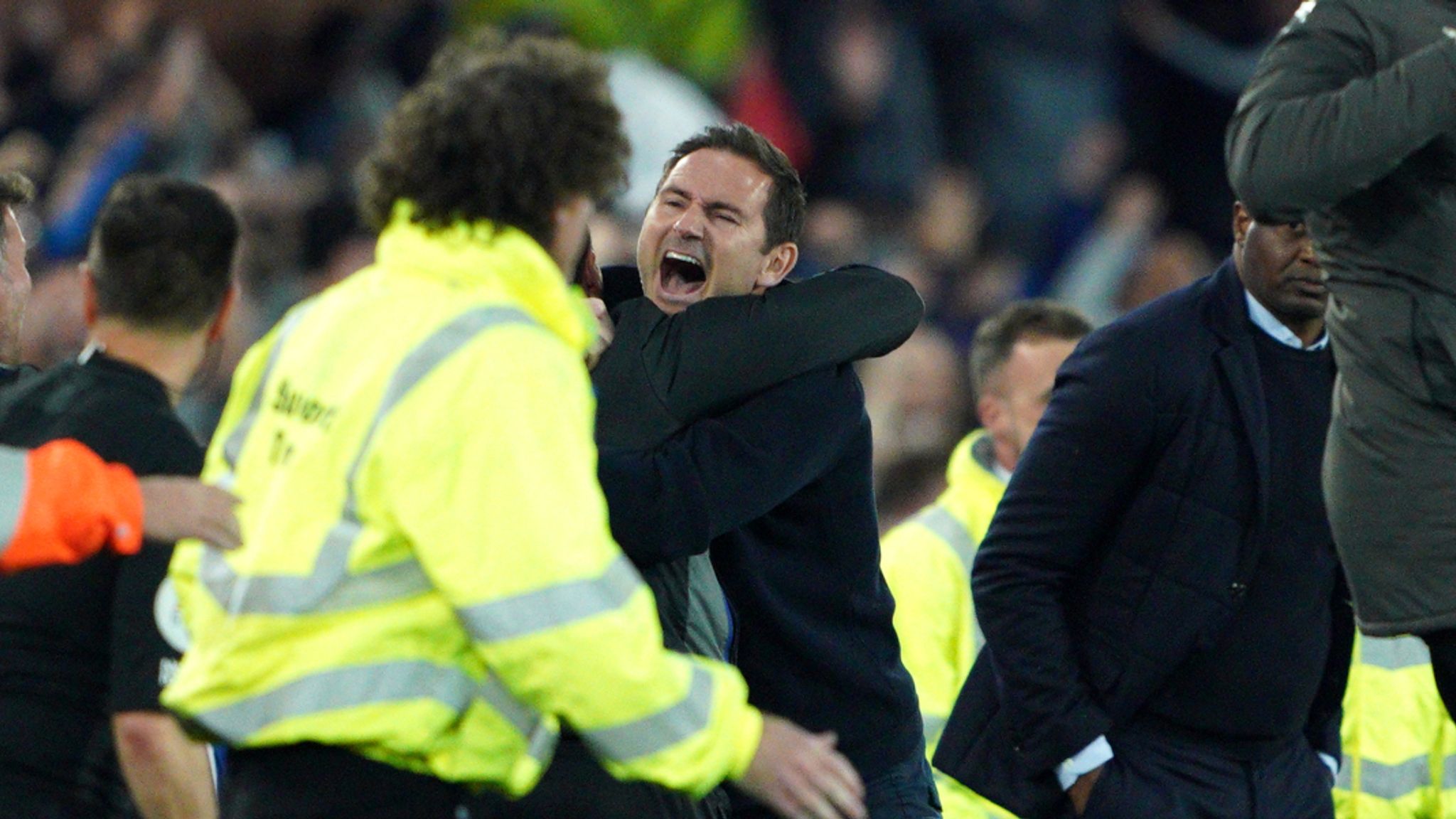 Lampard is mobbed before the pitch invasion