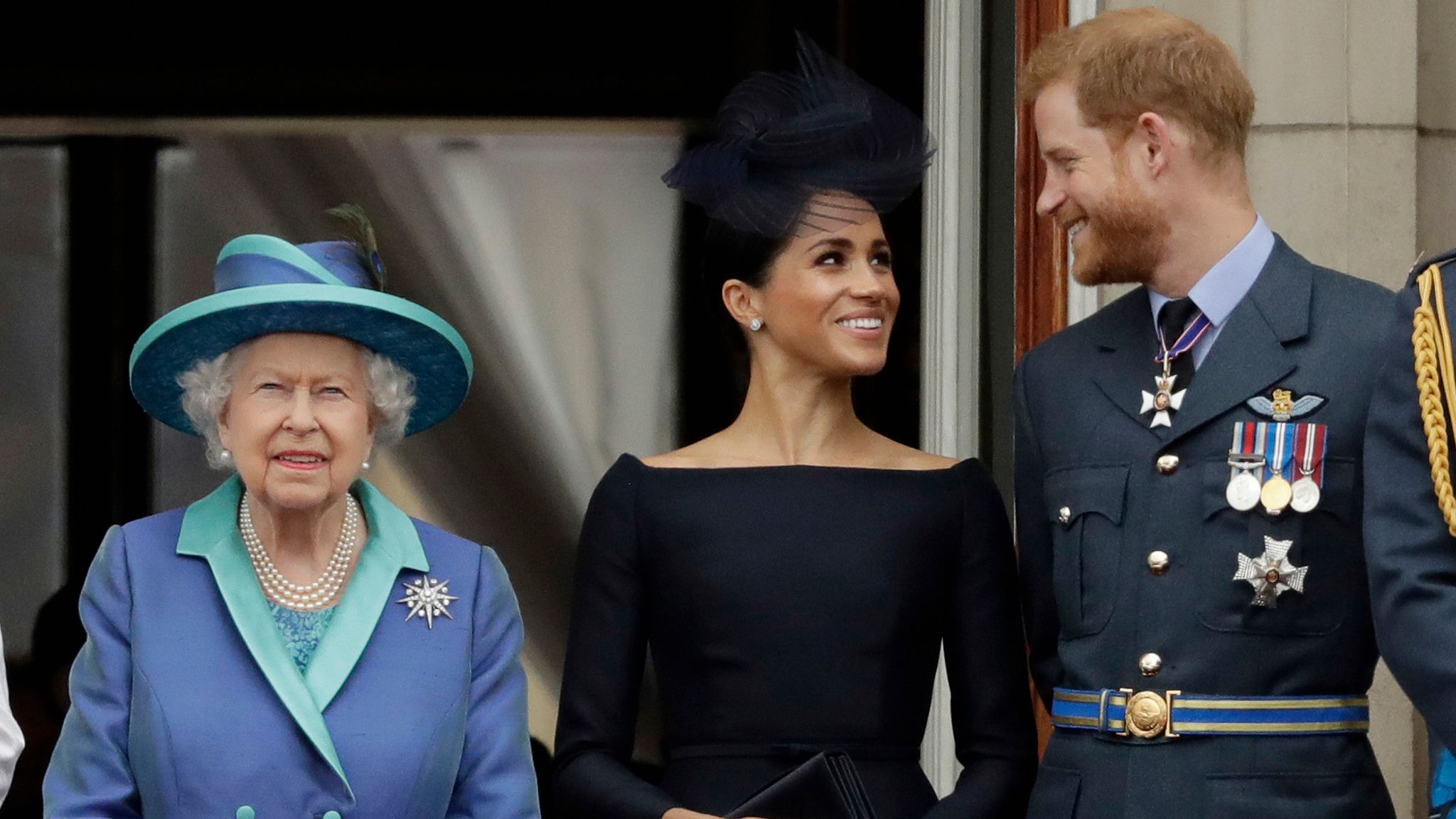 FILE - In this Tuesday, July 10, 2018 file photo Britain&#39;s Queen Elizabeth II, and Meghan the Duchess of Sussex and Prince Harry watch a flypast of Royal Air Force aircraft pass over Buckingham Palace in London. Prince Harry and Meghan Markle are to no longer use their HRH titles and will repay ..2.4 million of taxpayer&#39;s money spent on renovating their Berkshire home, Buckingham Palace announced Saturday, Jan. 18. 2020. (AP Photo/Matt Dunham, File) 