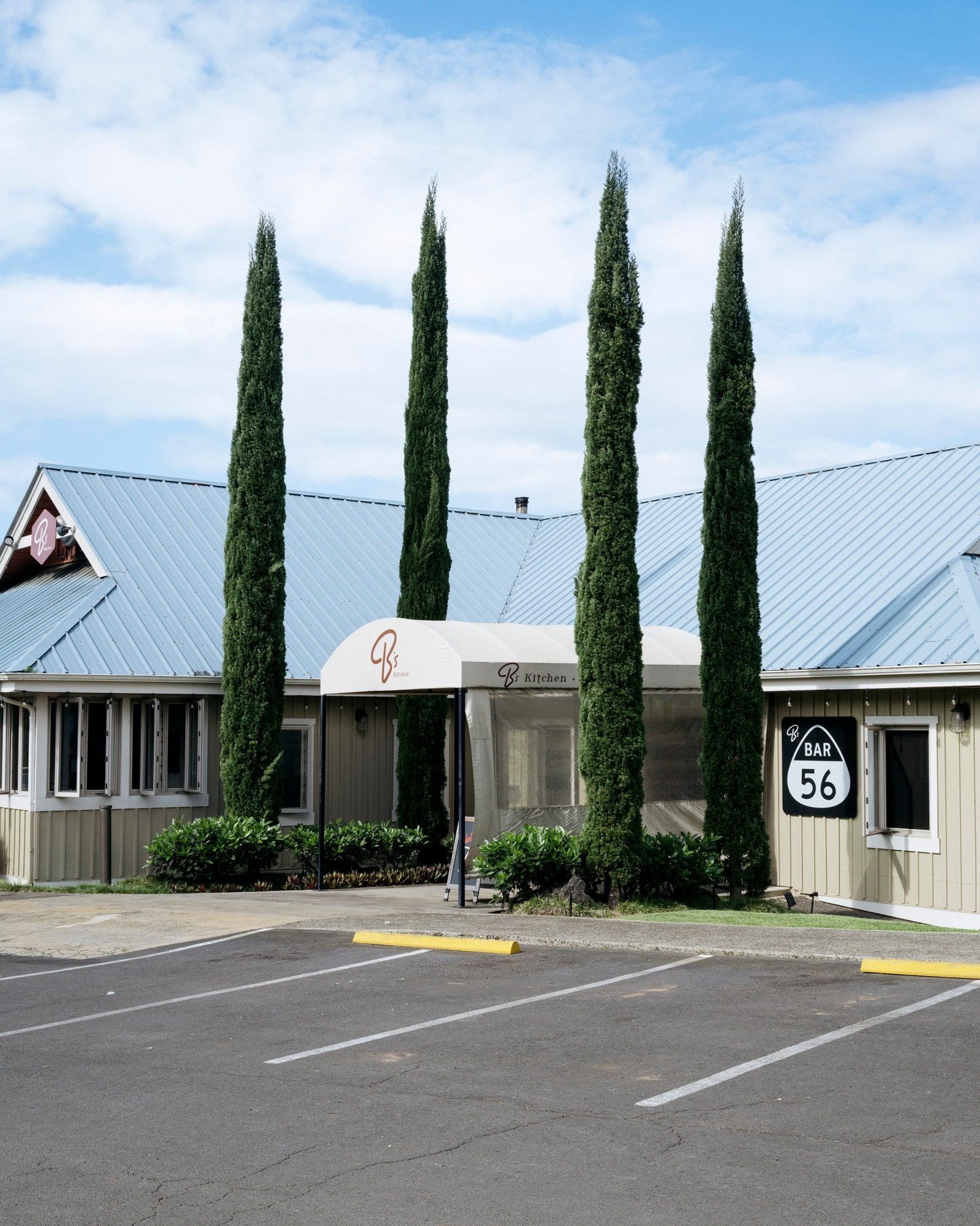 The exterior of a restaurant called B's Kitchen and the parking lot in front