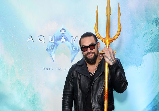 Actor Jason Momoa holds a trident at an event for his new film, "Aquaman and the Lost Kingdom" 