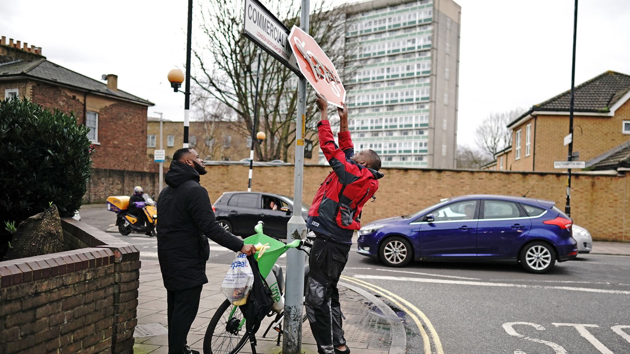 A person removes the Banksy artwork