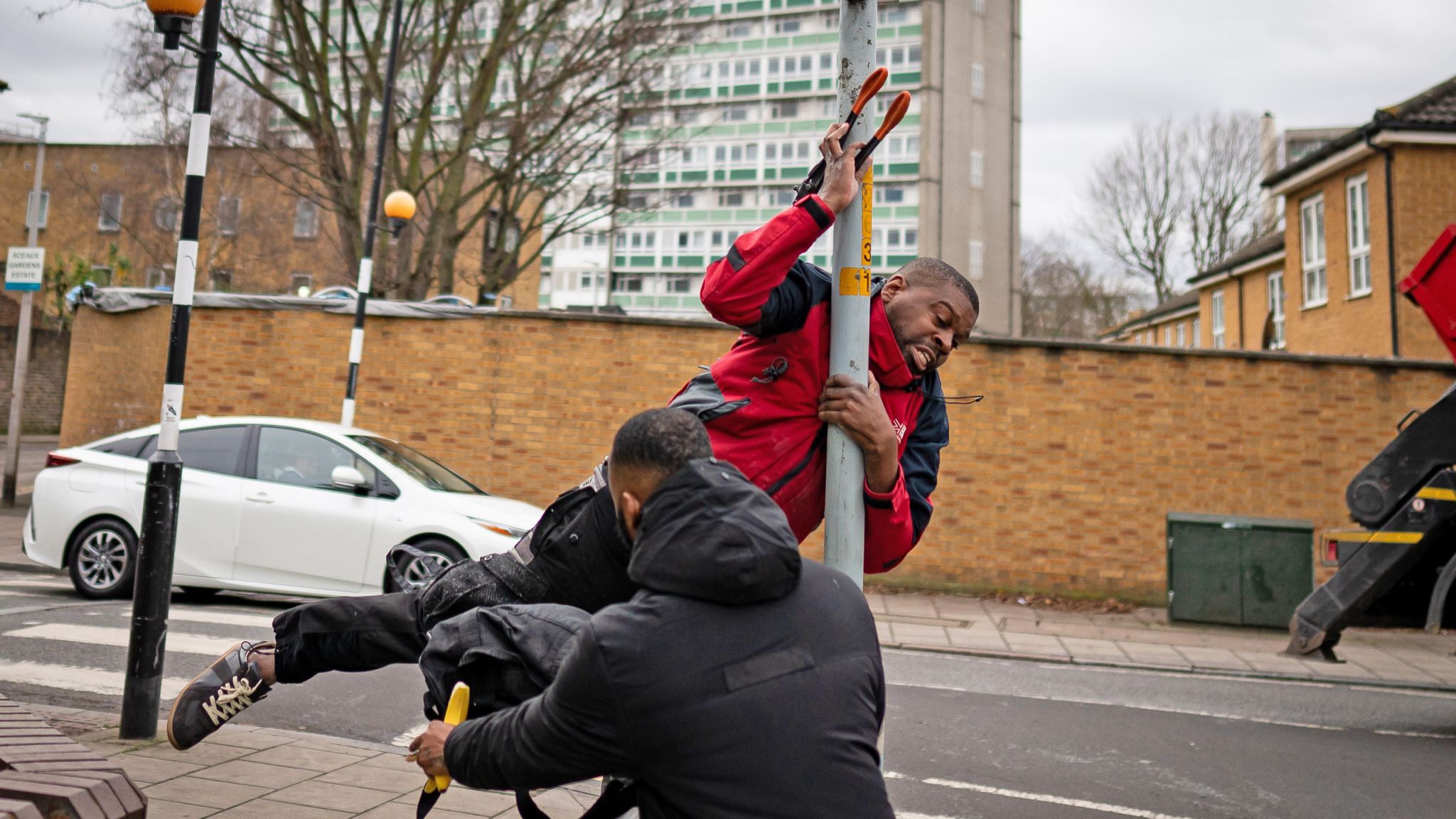 A person appears to slip as they remove the Banksy artwork