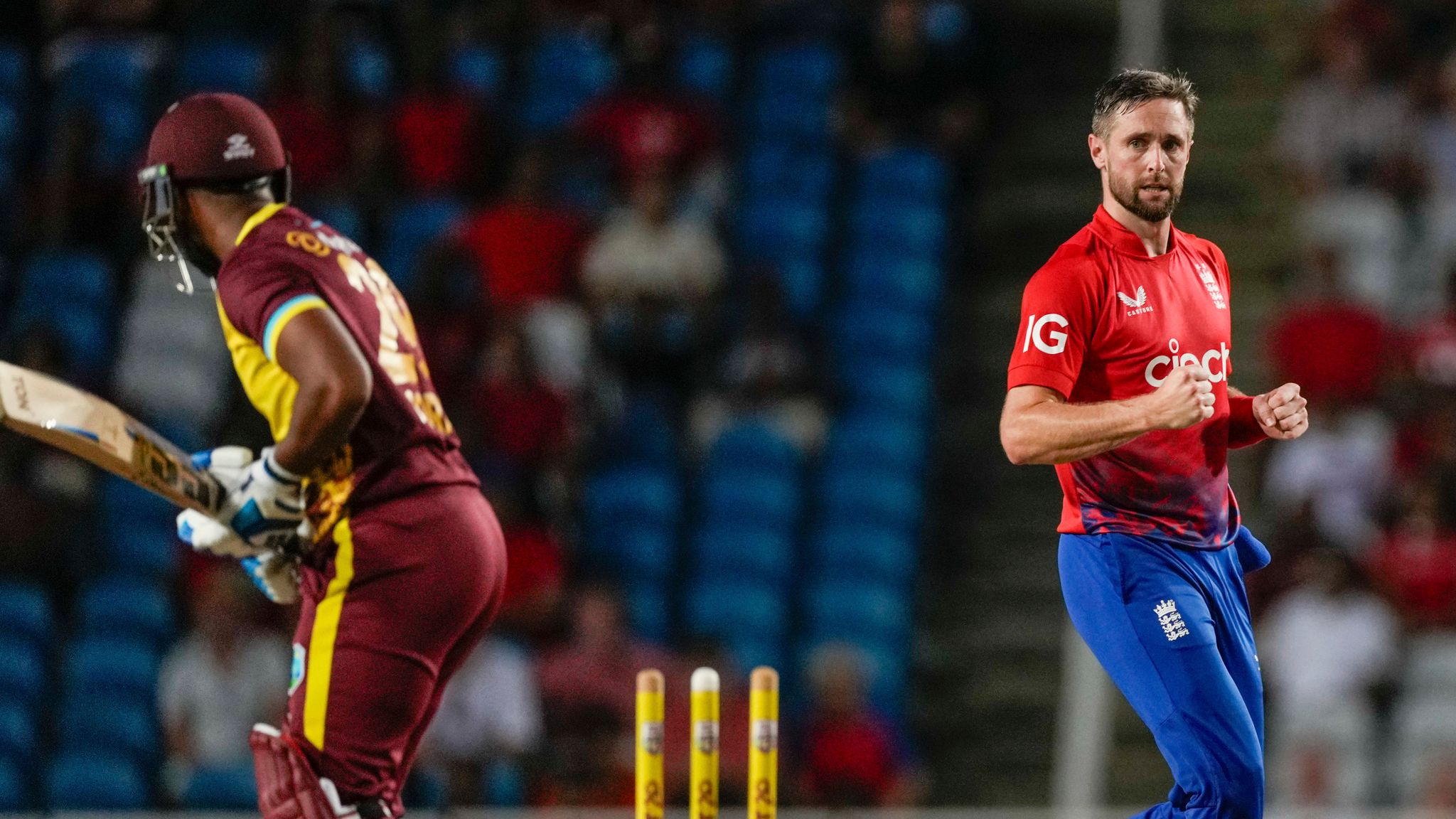 England&#39;s Chris Woakes..celebrates taking the wicket of West Indies&#39; Nicholas Pooran, left, during the fifth T20 cricket match at Brian Lara Stadium in Tarouba, Trinidad and Tobago, Thursday, Dec. 21, 2023. (AP Photo/Ricardo Mazalan)