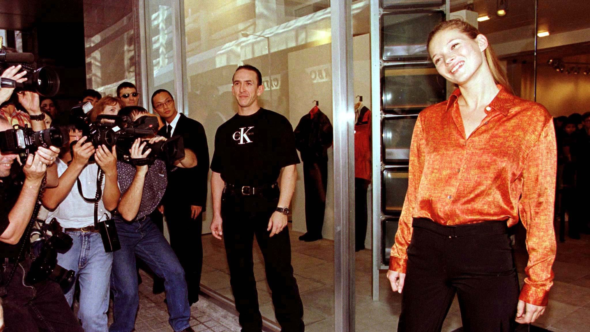 Supermodel Kate Moss (R) is surrounded by photographers outside Calvin Klein&#39;s first dedicated designer store for Hong Kong September 5. Moss, who models regularly for the designer and features in most of the company&#39;s advertising campaigns, flew in especially to mark the occasion. 