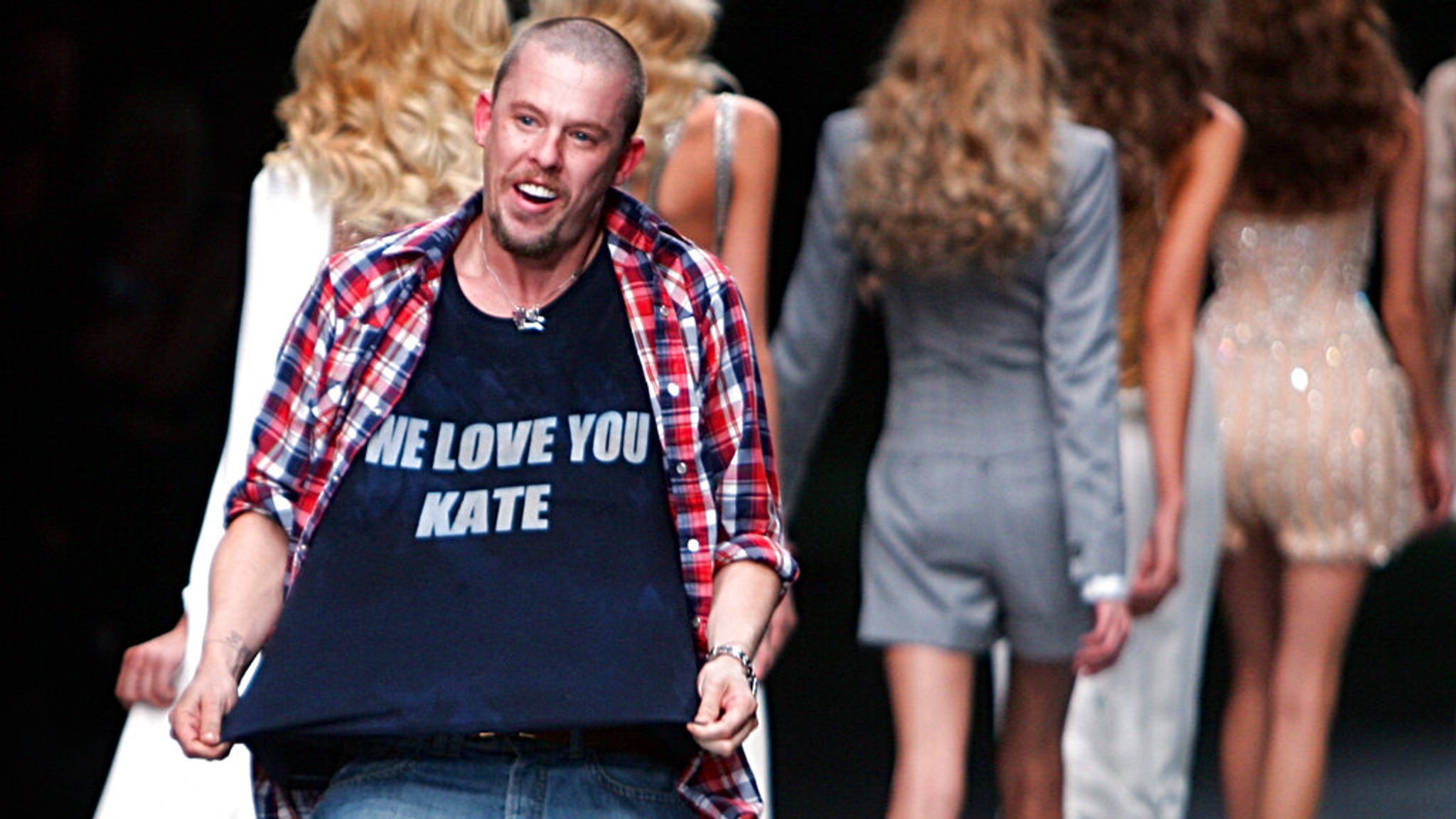 British fashion designer Alexander McQueen at the end of his Spring/Summer 2006 collection in Paris, Oct 7 2005. His shirt logo refers to Kate Moss after photos her apparently snorting cocaine in a London music studio were published in the Daily Mirror. Soon after she lost contracts with H&M, Burberry and Chanel. Pic: AP/Remy de la Mauviniere 