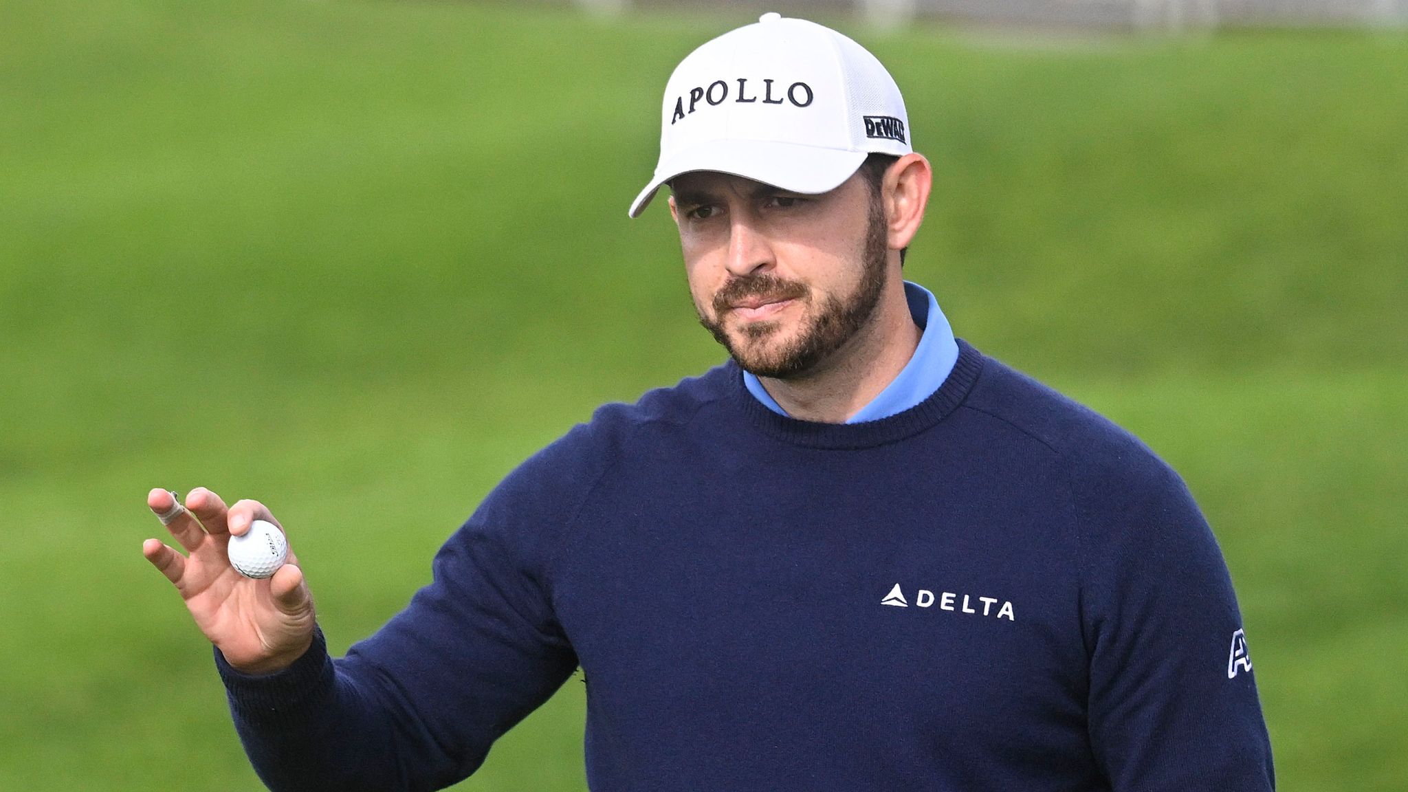 Patrick Cantlay holds up the ball after finishing the first round on the North Course at Torrey Pines, at the Farmers Insurance Open golf tournament Wednesday, Jan. 24, 2024, in San Diego. (AP Photo/Denis Poroy)