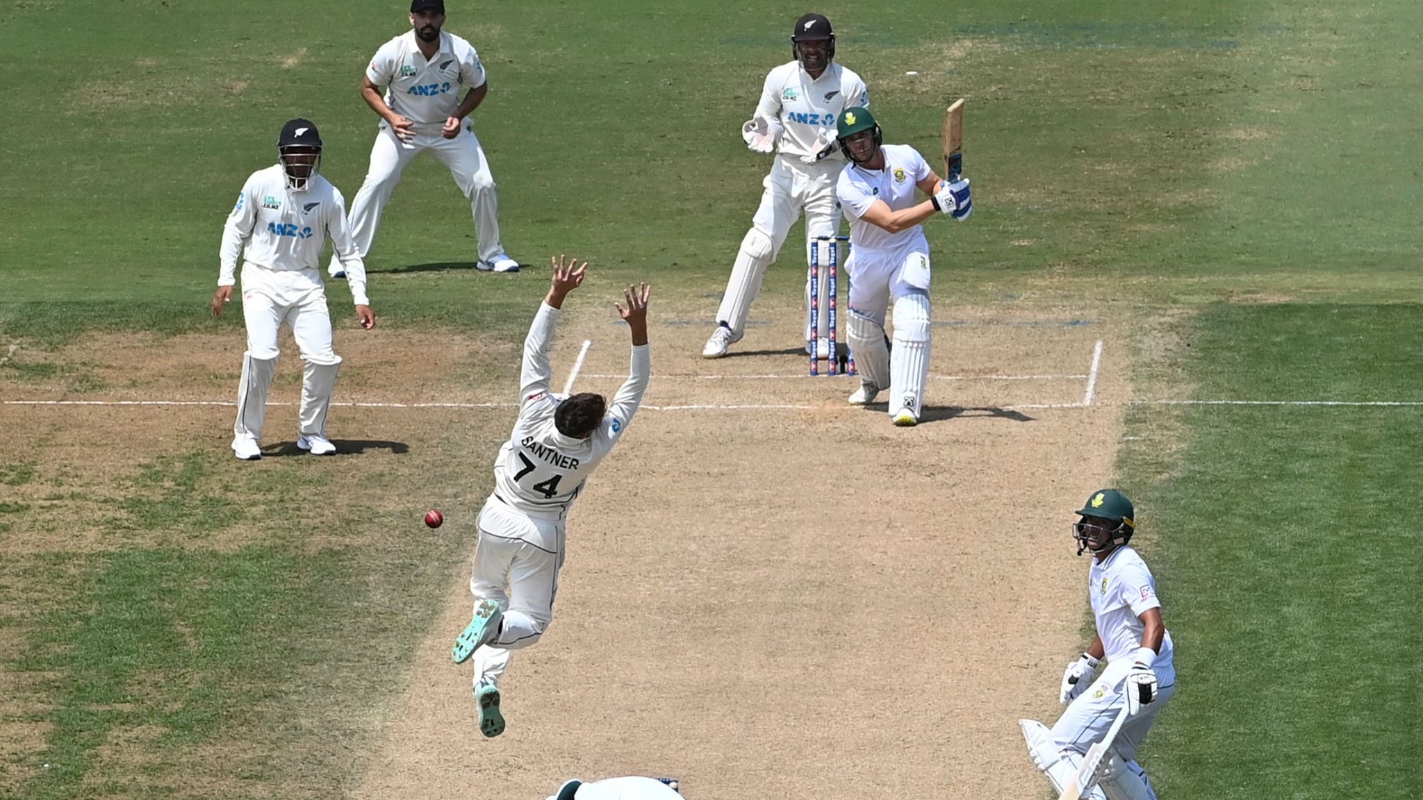 New Zealand's Mitch Santner leaps in the air as he attempts to take a catch off his own bowling on day four of the first cricket test between New Zealand and South Africa at Bay Oval, Mt Maunganui, New Zealand, Wednesday, Feb. 7, 2024. (Photo: Andrew Cornaga/Photosport via AP)