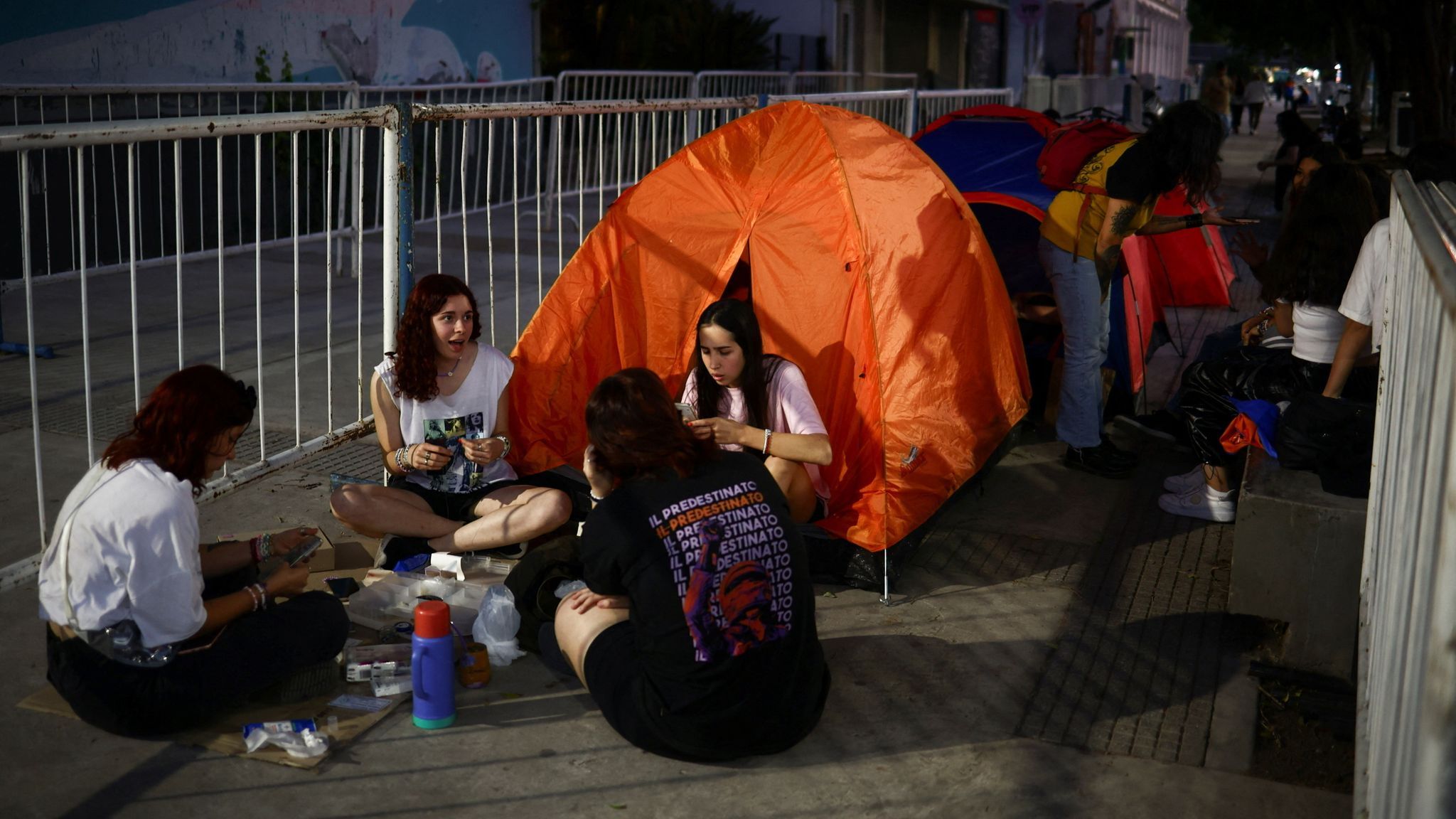 Taylor Swift fans sit outside their tent while lining up with others, some of them camping out for up to five months taking turns, to get a good spot at Swift&#39;s show, outside the Estadio Mas Monumental, in Buenos Aires, Argentina November 8, 2023. REUTERS/Tomas Cuesta