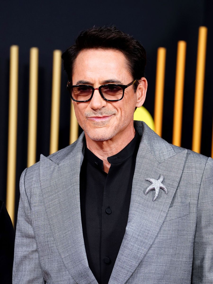 Robert Downey Jr in darks shades and grey suit- with a cheeky silver starfish just to mix it up