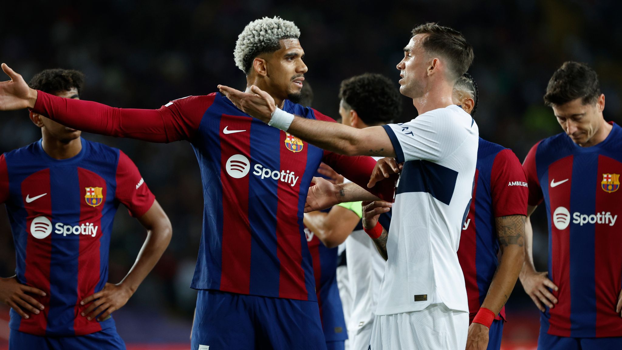 Araujo, left, and PSG's Fabian Ruiz argue after the red card