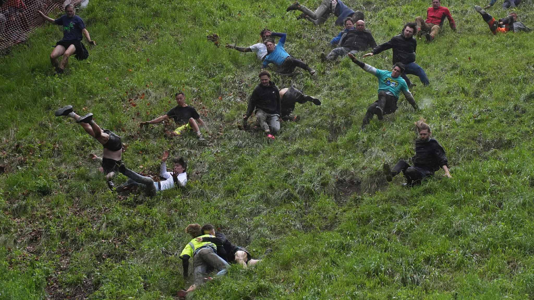 Pic: PA Participants take part in the annual cheese rolling at Cooper&#39;s Hill in Brockworth, Gloucestershire. Picture date: Monday May 27, 2024.