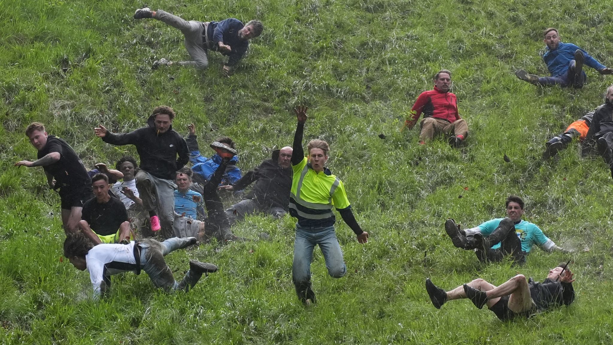 Pic: PA Participants take part in the annual cheese rolling at Cooper&#39;s Hill in Brockworth, Gloucestershire. Picture date: Monday May 27, 2024.