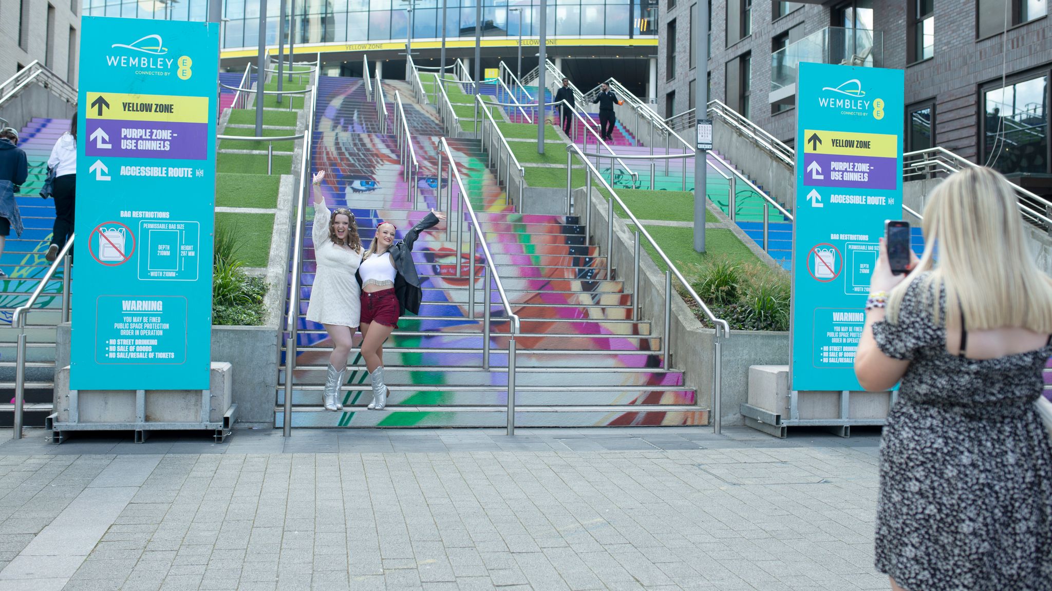 Fans pose on the Swiftie Steps at Wembley Stadium in London, ahead of Taylor Swift's first concert. Pic: PA