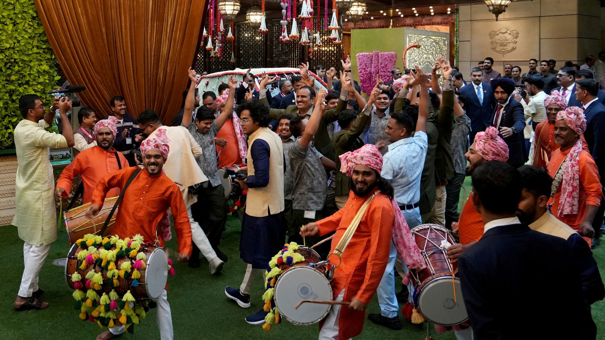 Drummers perform as staff members of Antilia, the house o Mukesh Ambani, dance on the day of the wedding. Pic: Reuters