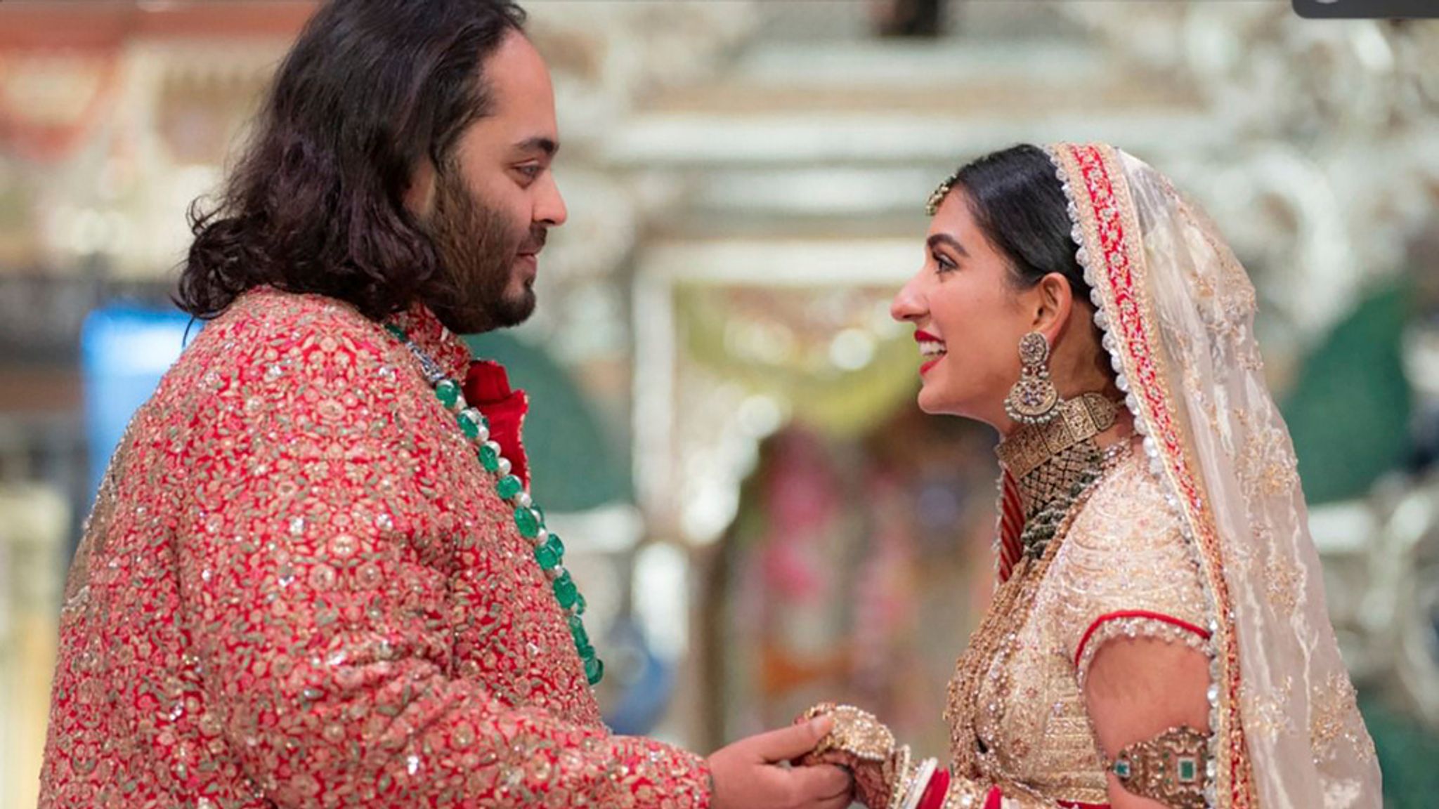 Anant Ambani, left, the son of billionaire Mukesh Ambani, holds hands with Radhika Merchant during their wedding ceremony