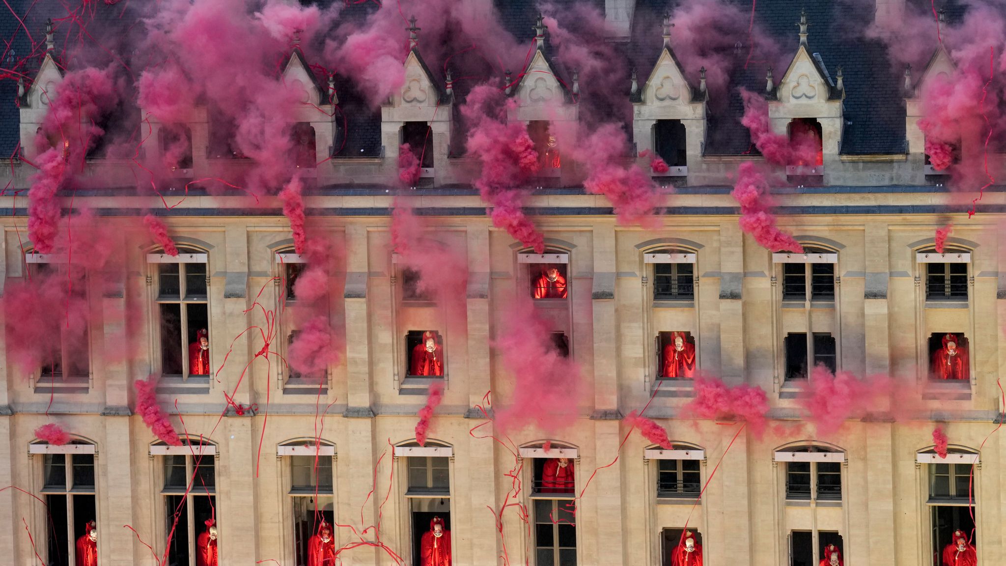 Smoke billows near windows as performers participate during the opening ceremony of the 2024 Summer Olympics. Pic: AP