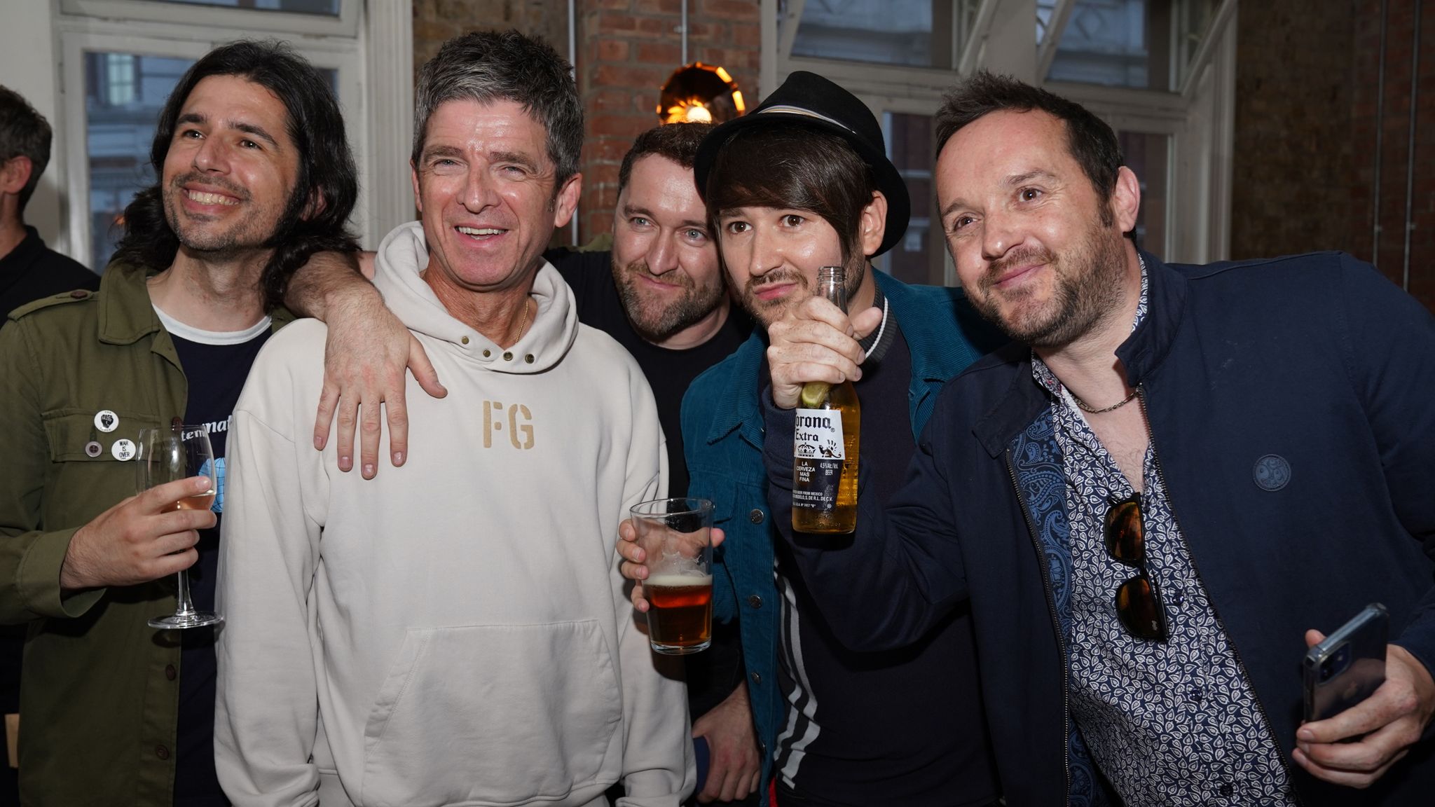 Noel Gallagher (second left) has his picture taken with fans at the world premiere of Oasis Knebworth 1996 at Picturehouse Central Cinema, central London. Picture date: Thursday September 16, 2021.