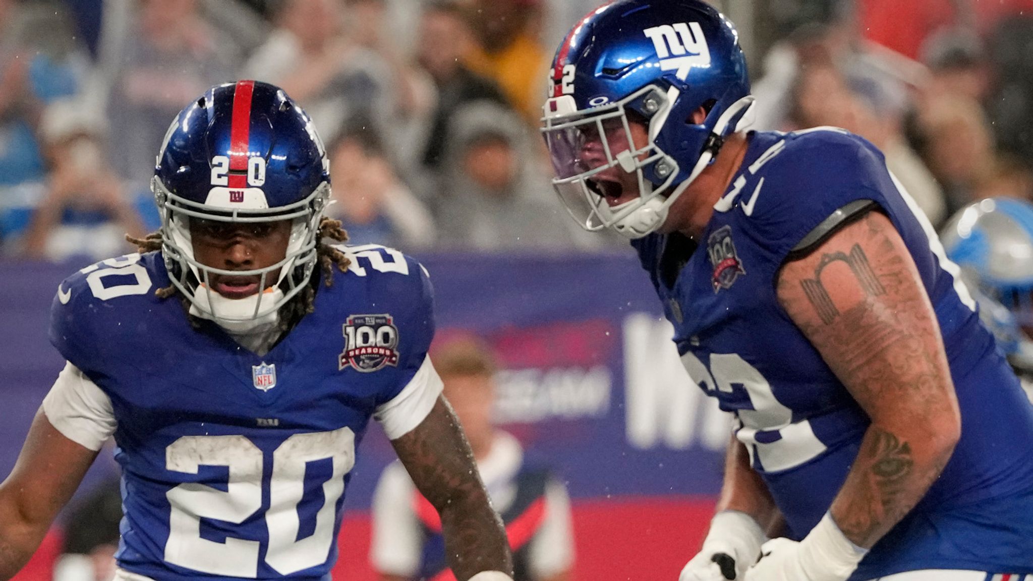 New York Giants running back Eric Gray (20) celebrates with New York Giants guard Jalen Mayfield (62) after scoring a touchdown against the Detroit Lions during the second quarter of an NFL football game, Thursday, Aug. 8, 2024, in East Rutherford, N.J. (AP Photo/Pamela Smith)