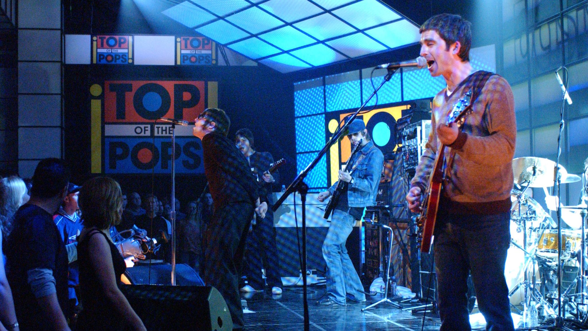 Noel Gallagher, right, and Liam Gallagher, of Oasis, appears on the television show "Top of the Pops" at BBC TV Studios in 2002. (AP Photo/Mark Allan)