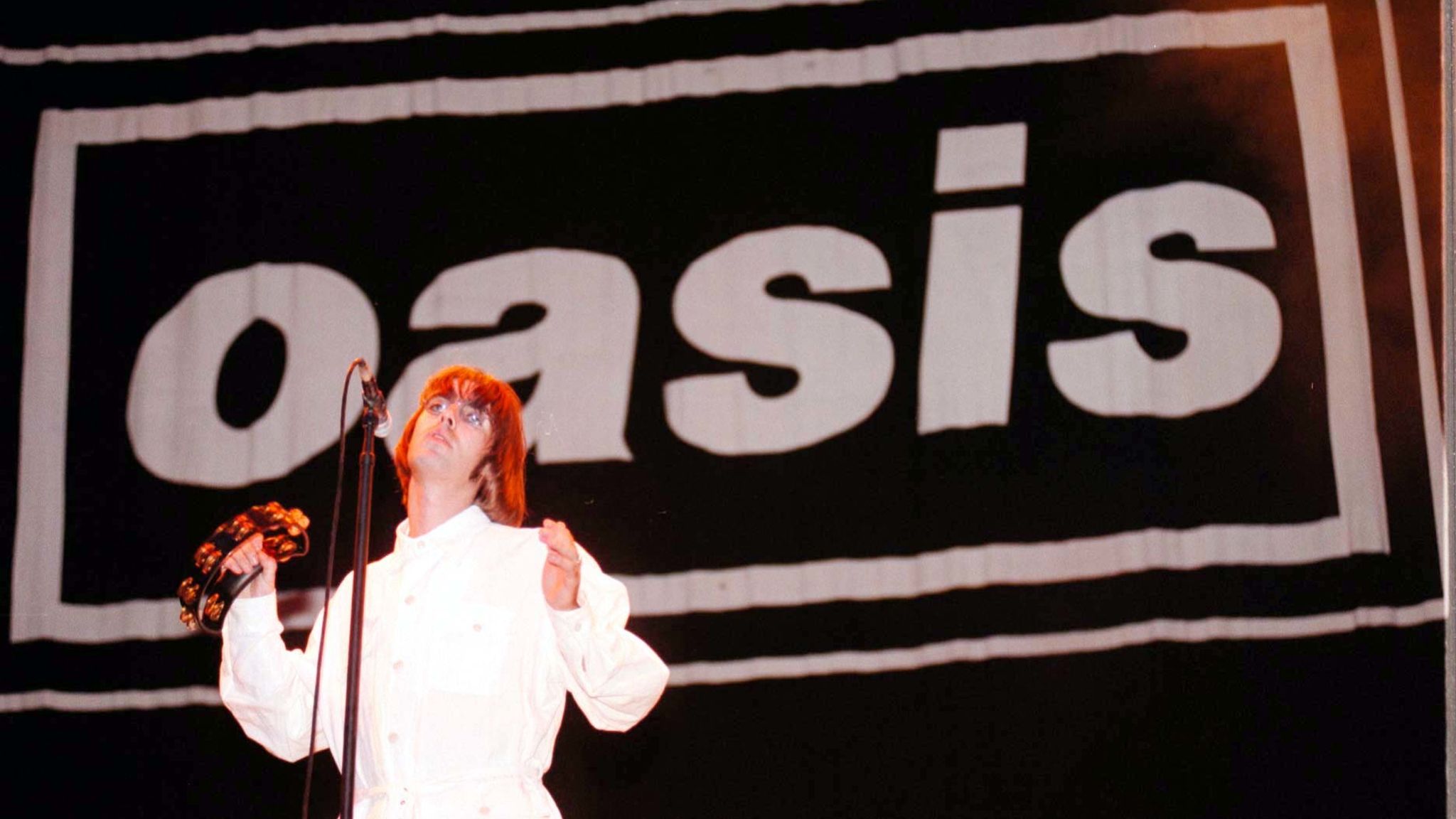 Liam Gallagher of Oasis in concert on stage at Knebworth House, Herts tonight (Sat). Photo by Stefan Rousseau/PA. Read less Picture by: Stefan Rousseau/PA Archive/PA Images Date taken: 10-Aug-1996