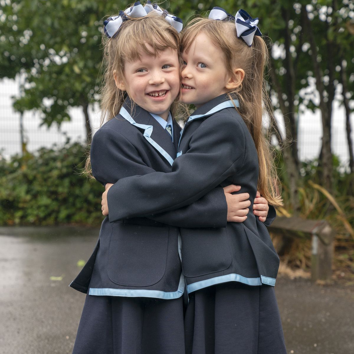 Twins Ellie Joanne and Hannah Margaret Wilson, due to start the new school term in the Inverclyde area, pose for a photograph at St Patrick's Primary School in Greenock, Inverclyde, ahead of their first day at school. Picture date: Tuesday August 13, 2024.