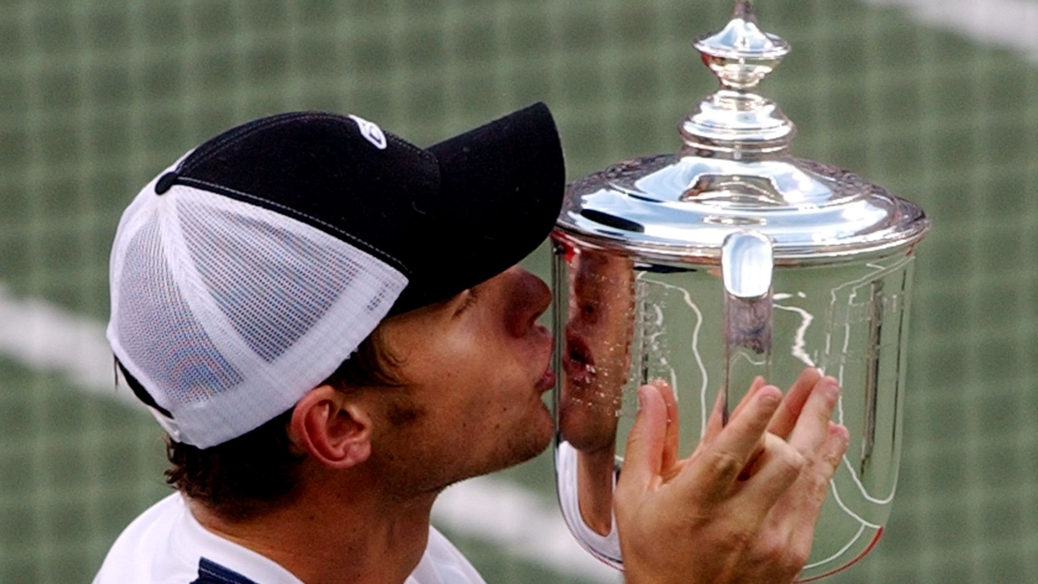 Andy Roddick, of the USA, kisses his trophy after his 6-3, 7-6 (2), 6-3 victory over Spain's Juan Carlos Ferrero to win the men's final at the US Open tennis tournament Sunday, Sept. 7, 2003 in New York. (AP Photo/Charles Krupa)