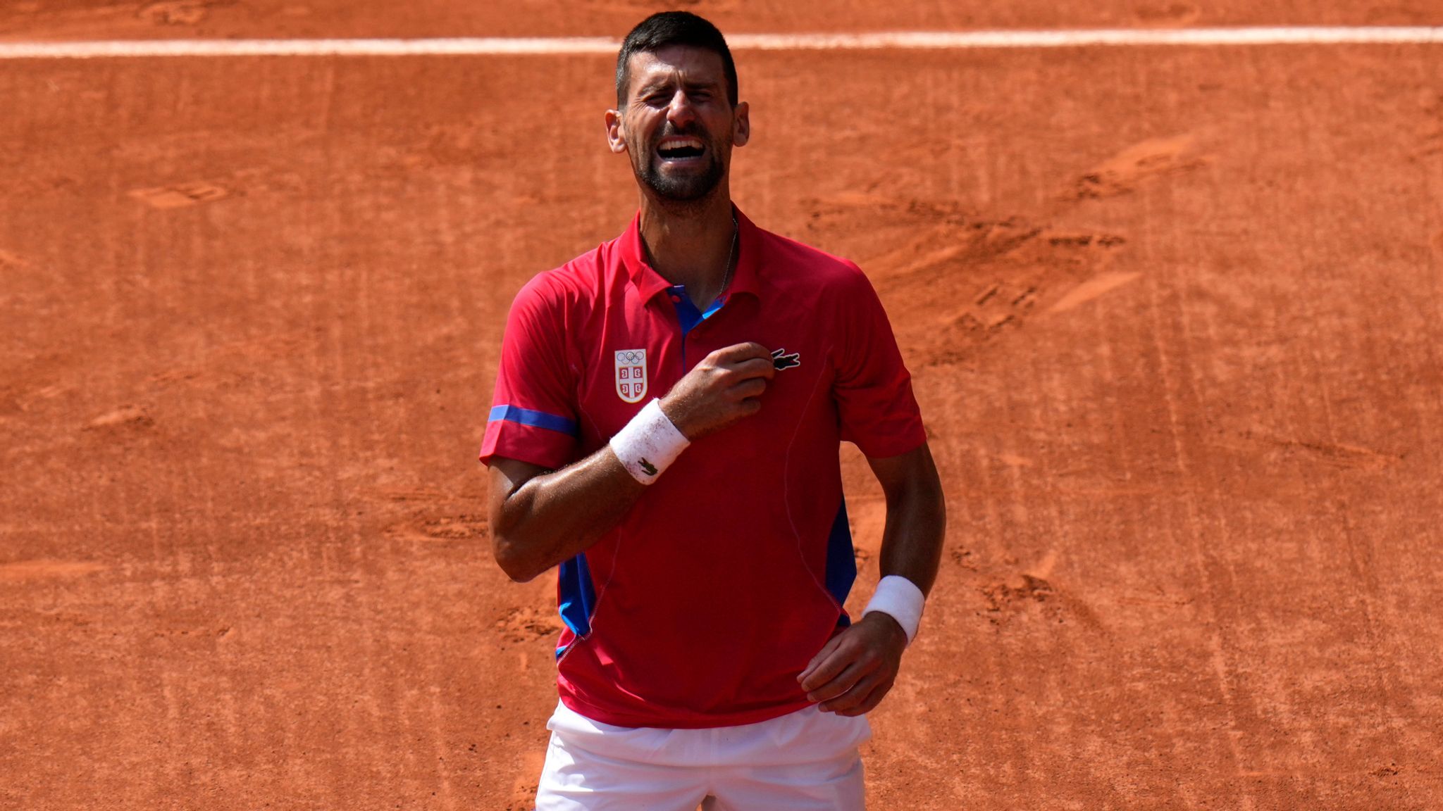 Serbia's Novak Djokovic reacts after defeating Spain's Carlos Alcaraz in the men's singles tennis final at the Roland Garros stadium during the 2024 Summer Olympics, Sunday, Aug. 4, 2024, in Paris, France. (AP Photo/Andy Wong)