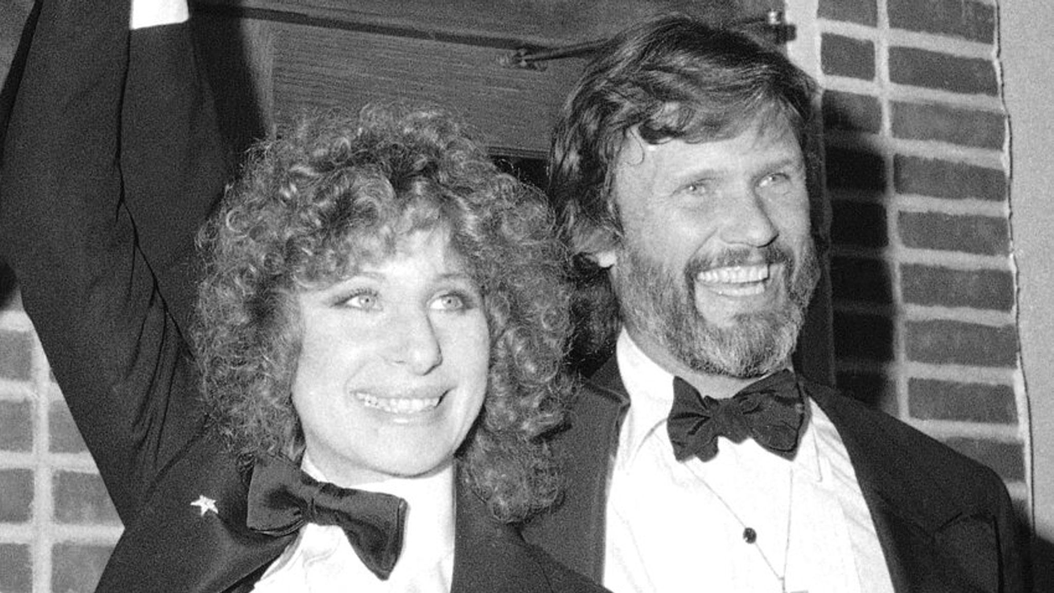 FILE - In this Dec. 23, 1976 file photo, producer Jon Peters, from left, Barbra Streisand and Kris Kristofferson appear at a preview of the film, "A Star is Born," in New York. Streisand is giving an early thumbs-up to the remake of ...A Star Is Born... with Lady Gaga and Bradley Cooper. Streisand and Kristofferson topped the 1976 version of the romantic drama about a rising performer and a fading star. (AP Photo/Suzanne Vlamis, File)