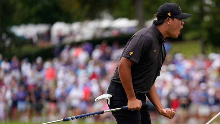 Si Woo Kim, of South Korea, reacts after his putt on the 15th green during their singles match at the Presidents Cup golf tournament at the Quail Hollow Club, Sunday, Sept. 25, 2022, in Charlotte, N.C.