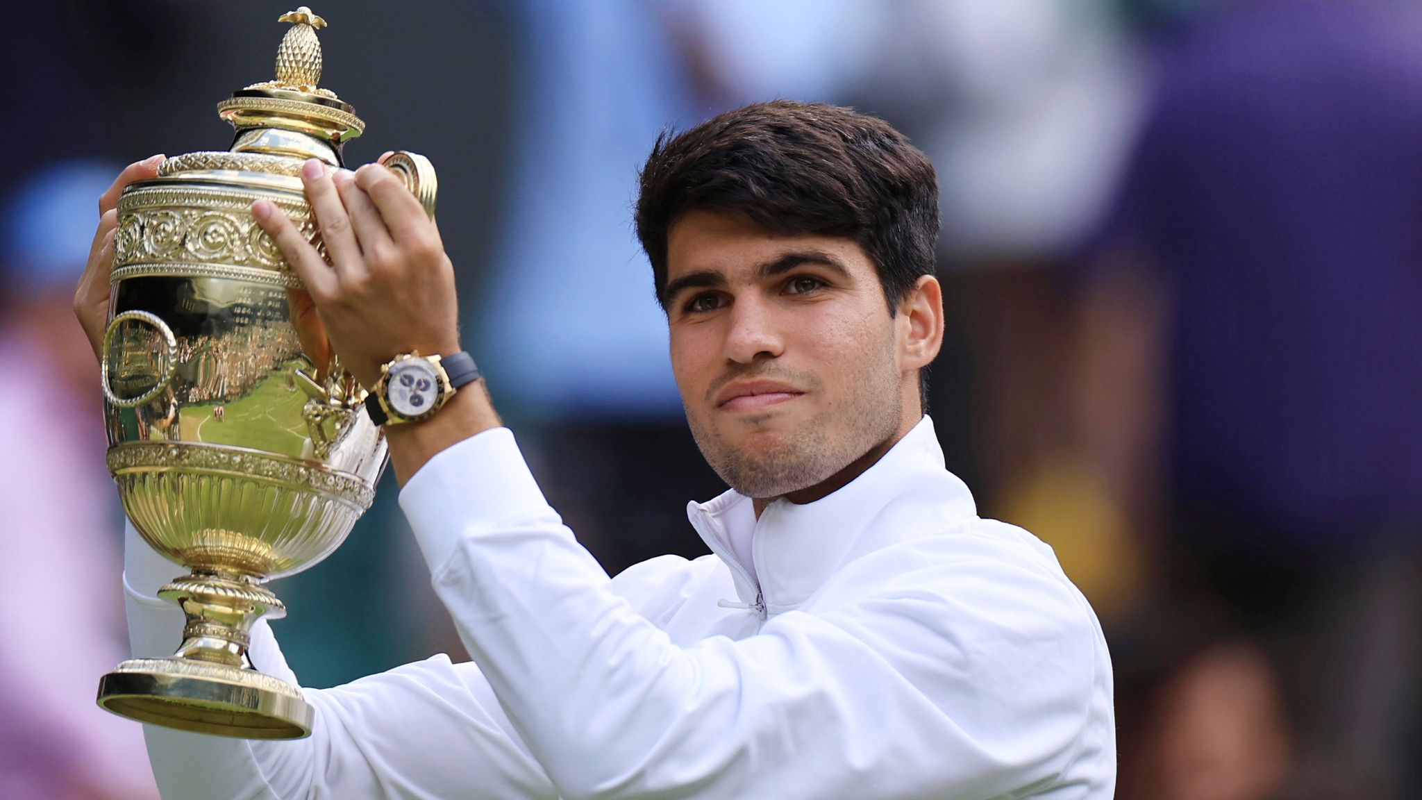 Carlos Alcaraz of Spain holds a trophy after winning the gentlemen's singles final match against Novak Djokovic of Serbia on the day 14 of the Wimbledon Tennis Championships at All England Lawn Tennis and Croquet Club in London, United Kingdom on July 14, 2024. Carlos Alcaraz won the match to claim his consecutive victory.( The Yomiuri Shimbun via AP Images )