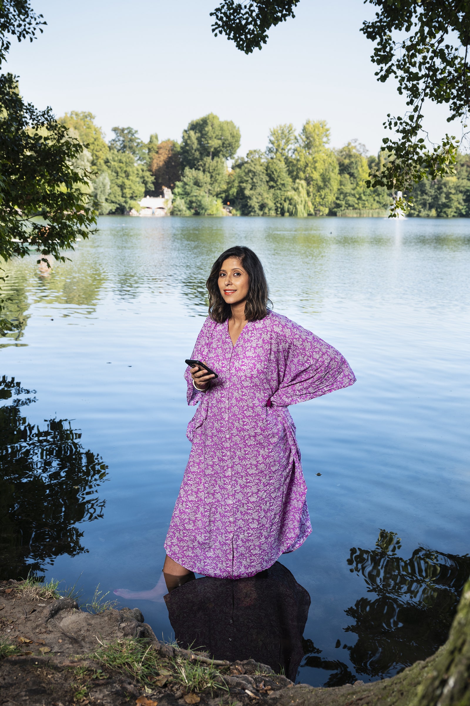 Image may contain Blouse Clothing Face Head Person Photography Portrait Nature Outdoors Pond Water and Plant