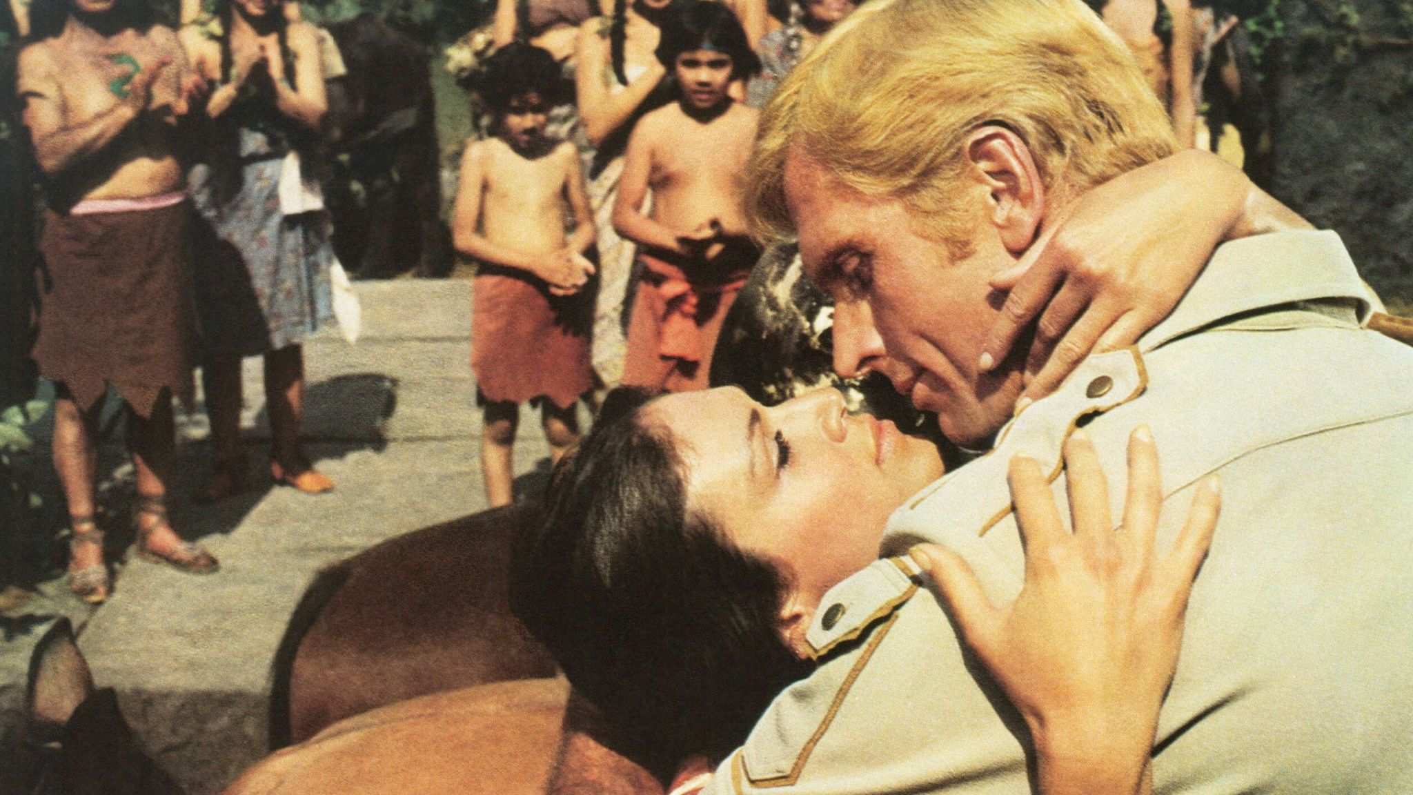 1975: Ron Ely as Doc Savage: The Man of Bronze in a passionate embrace with Pamela Hensley Pic: Everett/Shutterstock