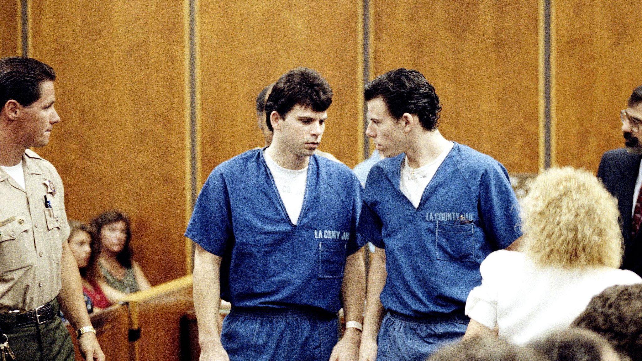 Lyle, left, and Erik Menendez leave courtroom in Santa Monica, Calif., Aug. 6, 1990, after a judge ruled that conversations between the two brothers and their psychologist after their parents were slain are not privileged and can be used as evidence in their murder case. (AP Photo/Nick Ut)