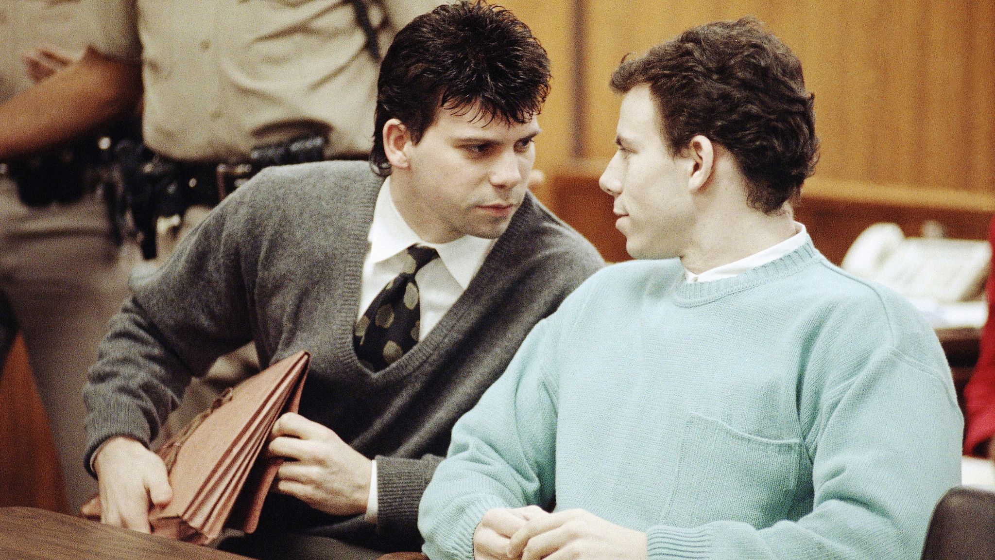 Lyle Menendez, left confers with brother Erik during a court appearance, April 2, 1991 in Beverly Hills, California. Lawyers for the brothers won another delay of a preliminary hearing while they seek a state Supreme Court opinion on whether an alleged murder confession is protected by doctor-patient privilege. (AP Photo/Kevork Djansezian) 