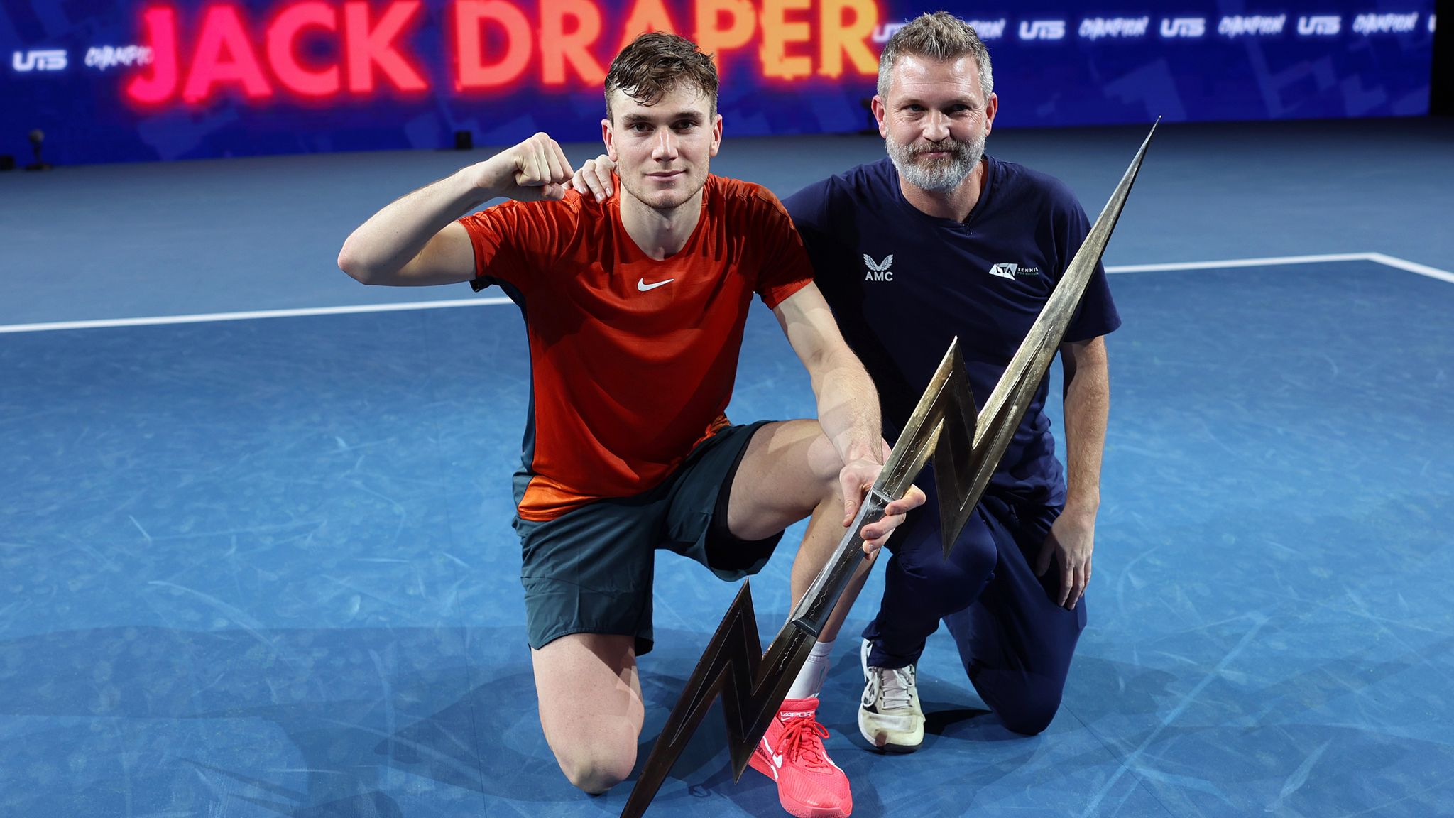 Jack Draper of Great Britain and coach James Trotman with the trophy after winning the Final match against Holger 'The Viking' Rune of Denmark during Day Three of the UTS Grand Final London at ExCel London on December 17, 2023 in London, England. (Photo by Julian Finney/Getty Images for UTS)