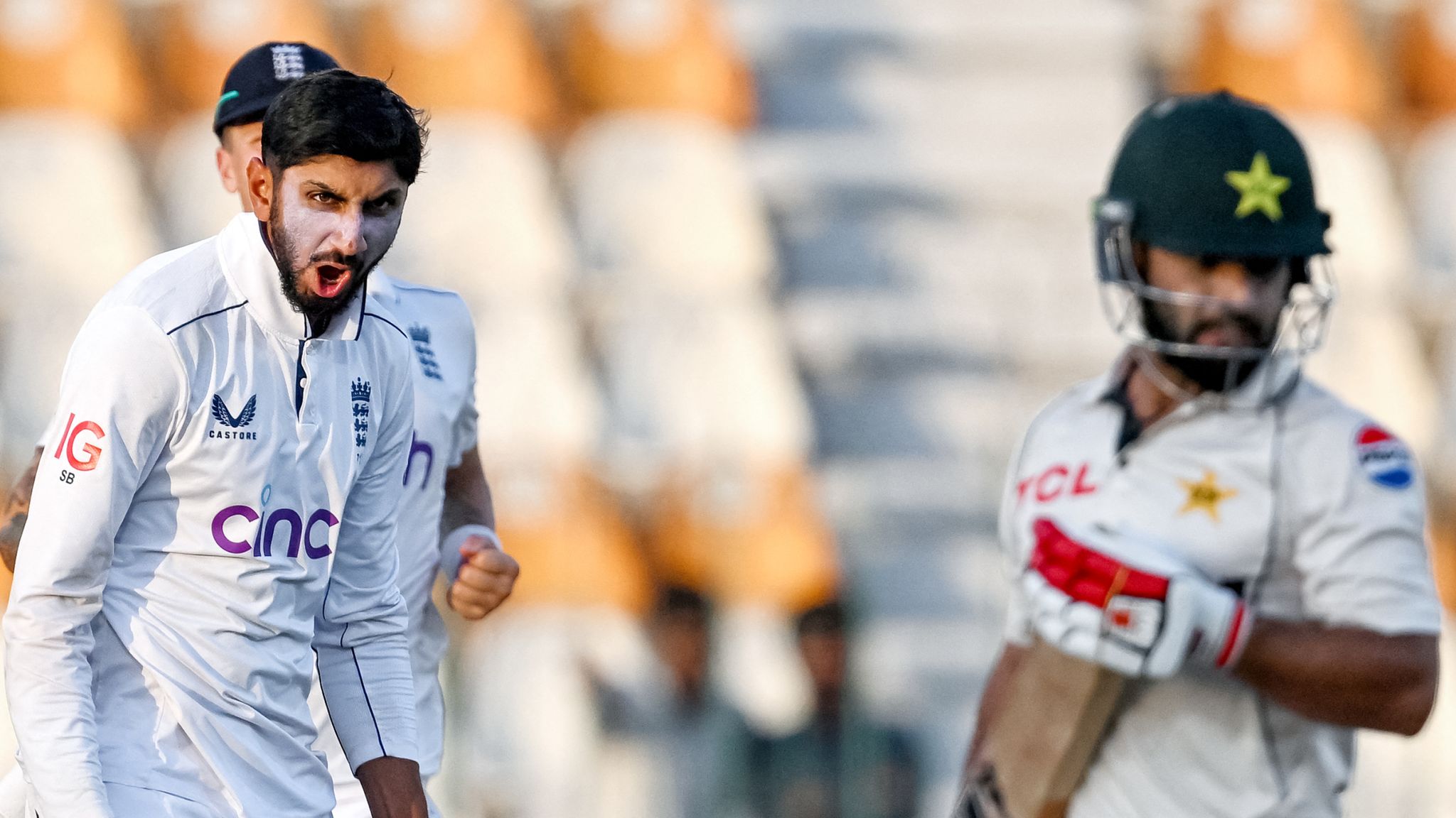 England's Shoaib Bashir (L) celebrates after taking the wicket of Pakistan's Kamran Ghulam during the first day of the second Test cricket match between Pakistan and England at the Multan Cricket Stadium in Multan on October 15, 2024. (Photo by Farooq NAEEM / AFP)