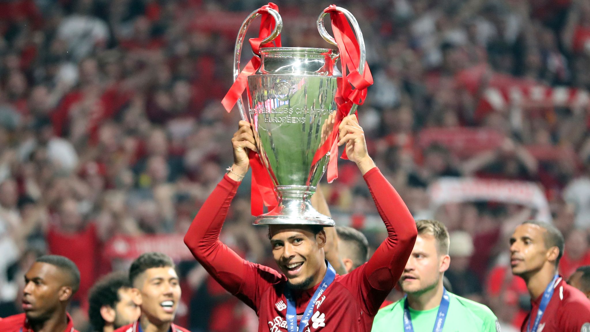 Virgil van Dijk lifts the Champions League trophy in 2019.