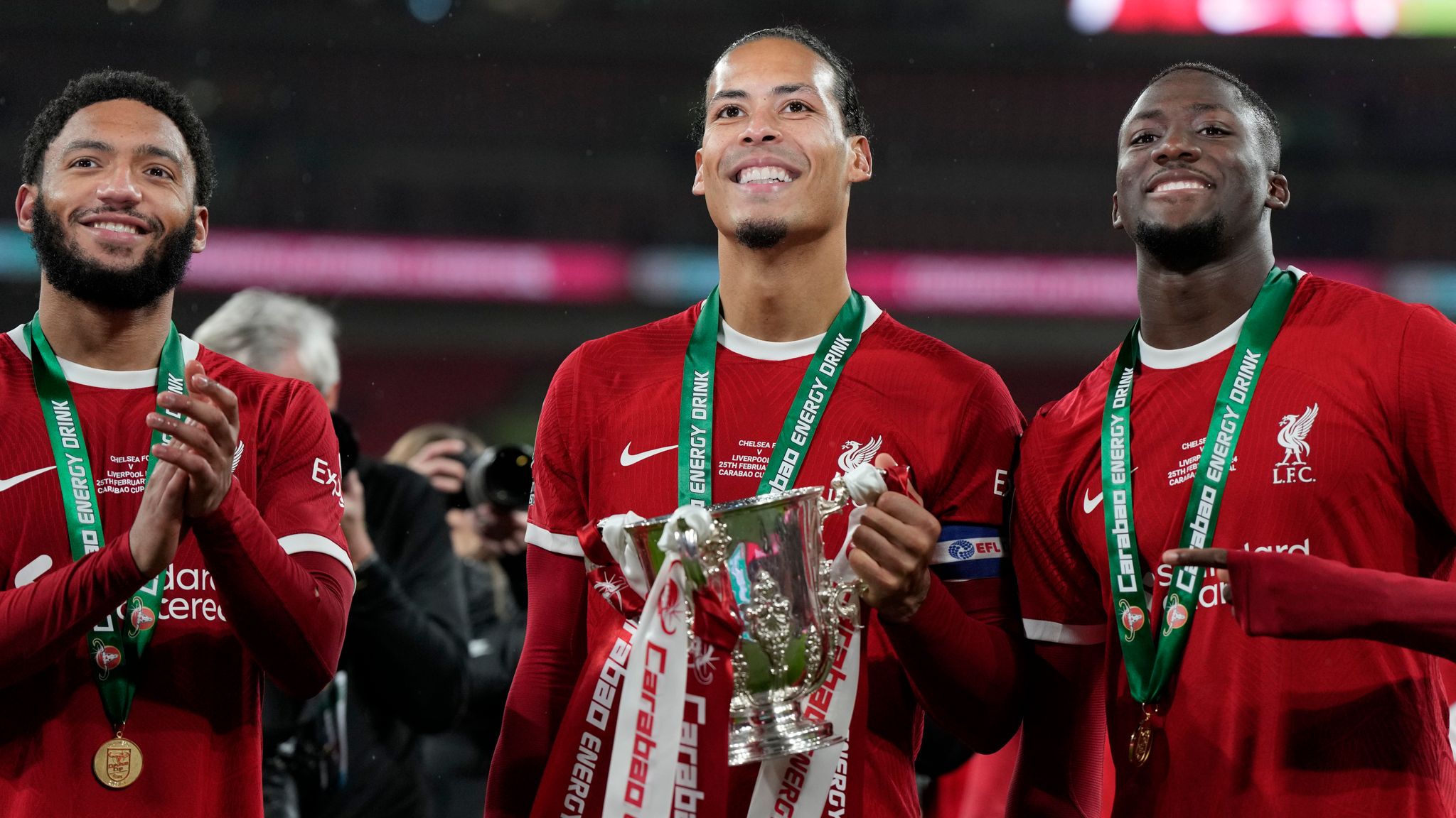 Liverpool's Virgil van Dijk (middle) holds the Carabao Cup trophy.