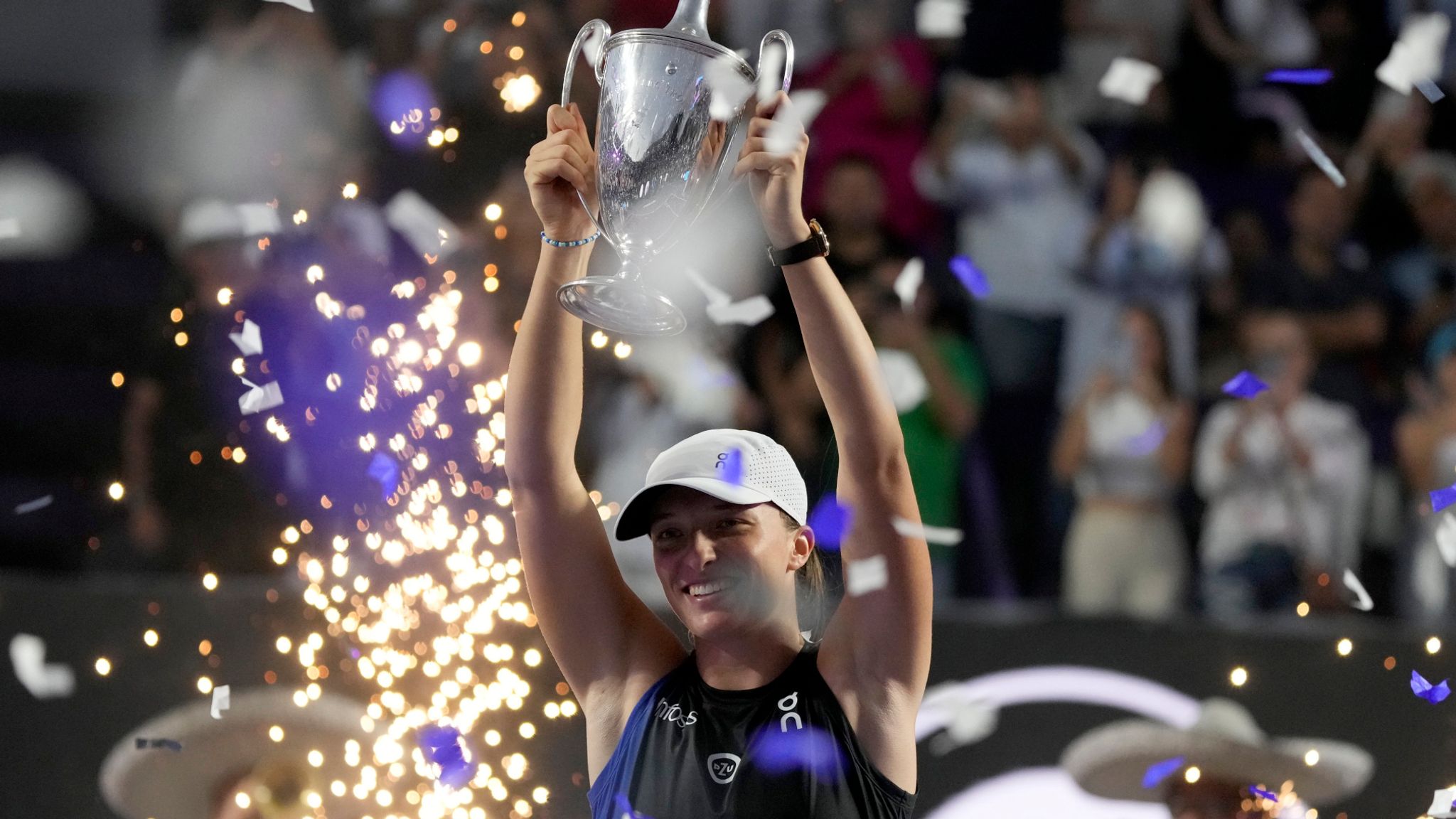 Iga Swiatek, of Poland, hold her trophy after her victory over Jessica Pegula, of the United States, in the women's singles final of the WTA Finals tennis championships, in Cancun, Mexico, Monday, Nov. 6, 2023. (AP Photo/Fernando Llano)