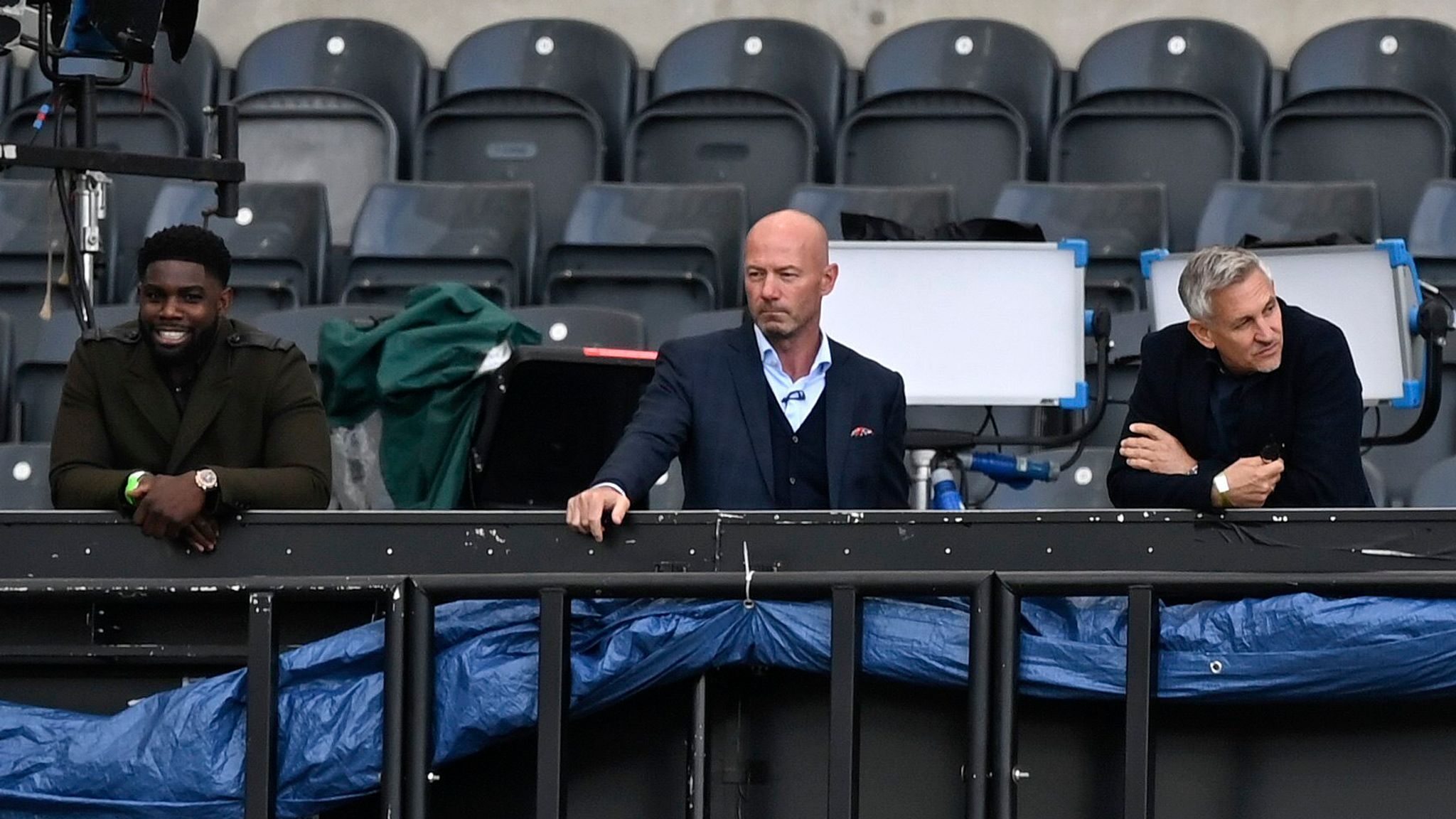 FILE - TV soccer pundits and former soccer players Micah Richards, Alan Shearer and Gary Lineker, from left, watch the FA Cup sixth round soccer match between Newcastle United and Manchester City at St. James' Park in Newcastle, England, Sunday, June 28, 2020. (Shaun Botterill/Pool via AP, File)