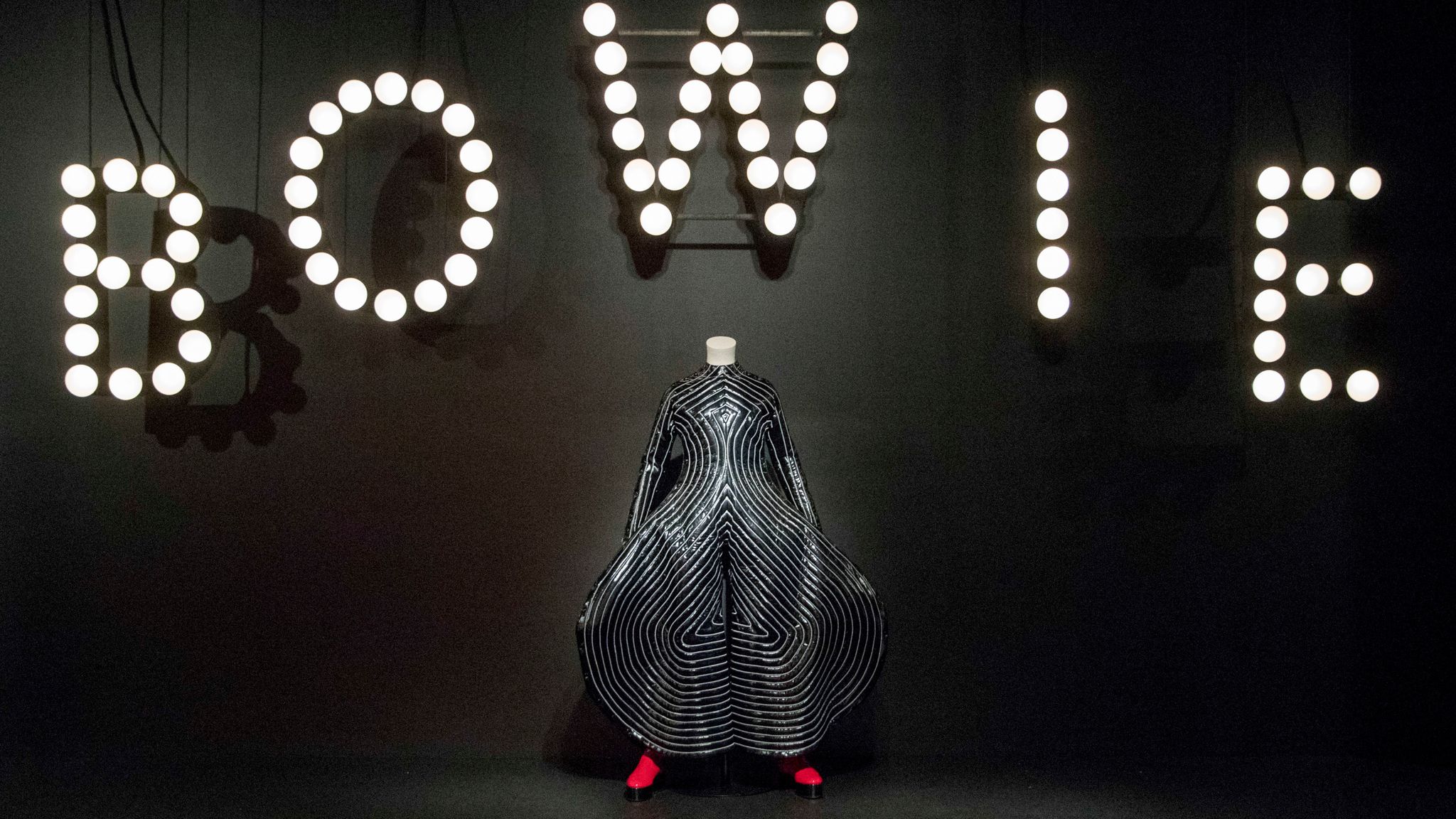 The "Tokyo Pop" body suit with replica shoes, designed by Kansai Yamamoto from the "Aladdin Sane" tour are on display during the media preview of the "David Bowie is" exhibit at the Brooklyn Museum, Wednesday, Feb. 28, 2018, in New York. The exhibit opens to the public on March 2 and runs through July 15. (AP Photo/Mary Altaffer) 