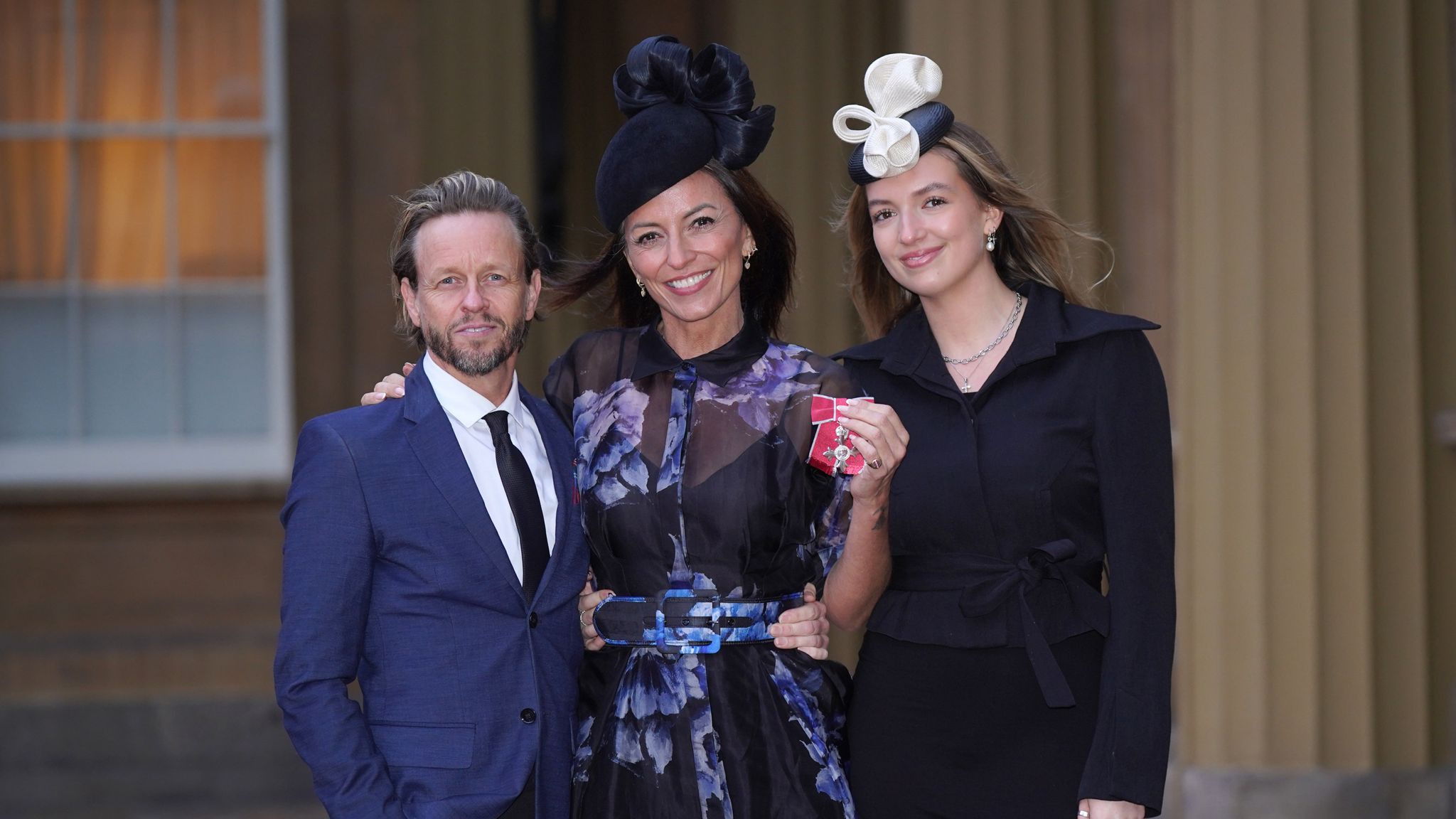 Davina McCall with her partner Michael Douglas and her daughter Holly Robertson after being made a Member of the Order of the British Empire Pic: PA