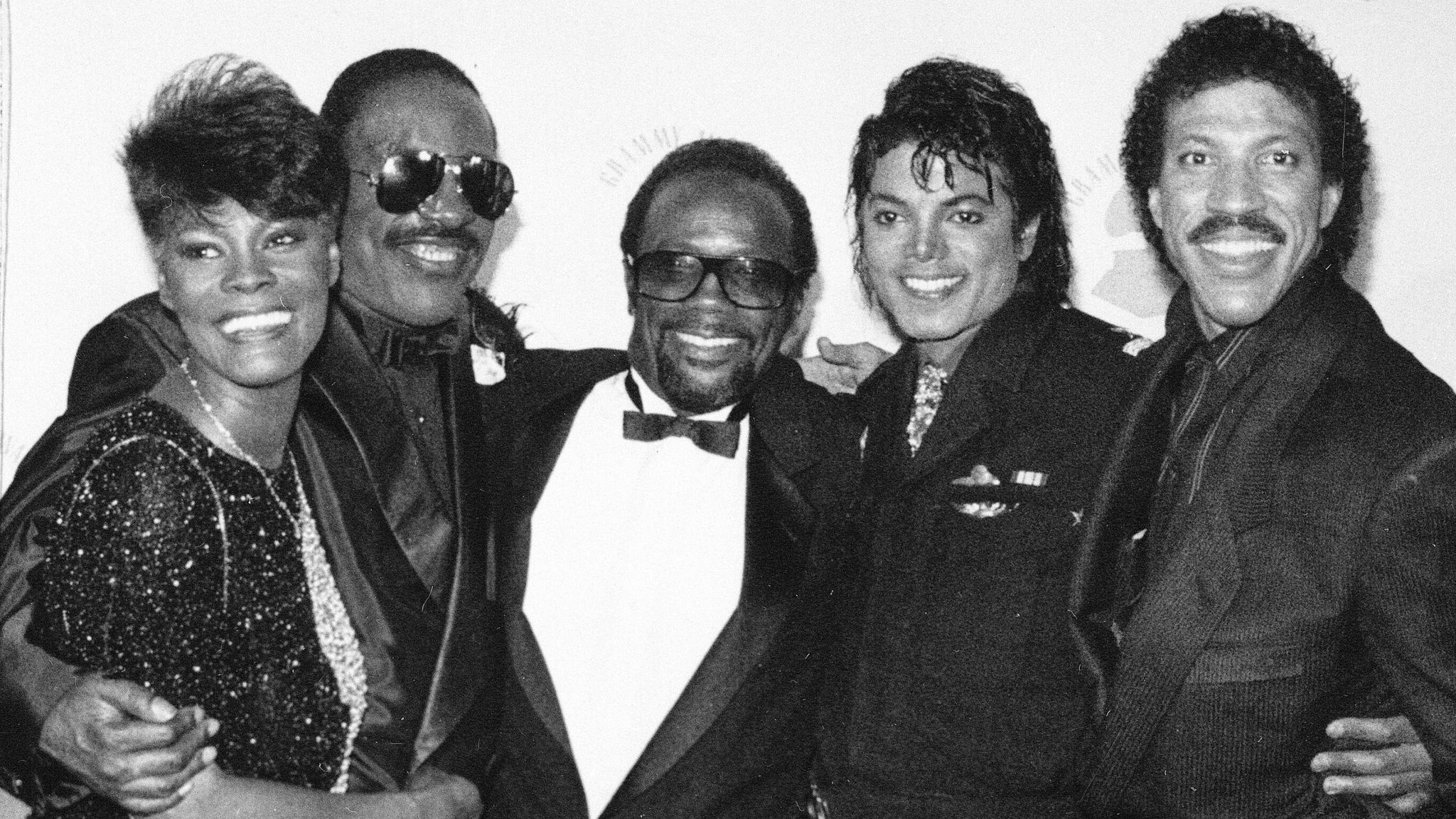 Grammy winners Dionne Warwick, Stevie Wonder, Quincy Jones, Michael Jackson and Lionel Richie pose together backstage at the Grammy Awards show in Los Angeles, on February 26, 1986. (AP Photo)