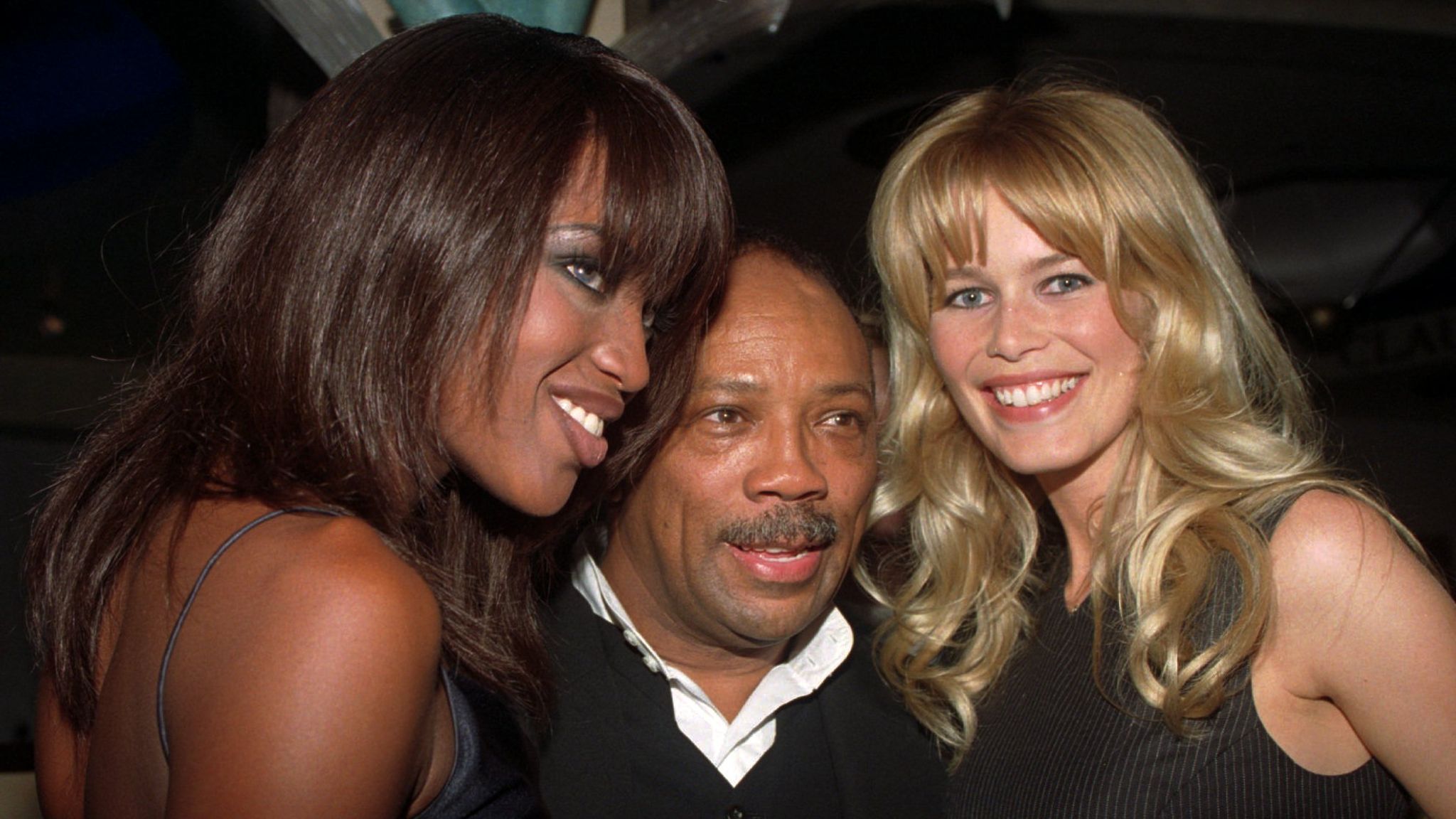 Supermodels Naomi Campbell, left, and Claudia Schiffer flank music impresario Quincy Jones at New York's Fashion Cafe Wednesday, July 5, 1995, during a party to welcome new investor in the Fashion Cafe - supermodel Christy Turlington. Owner Tomasso Buti announced the planned opening of Fashion Cafe London in the summer of 1996, at a news conference earlier in the evening. (AP Photo/Paul Hurschmann)