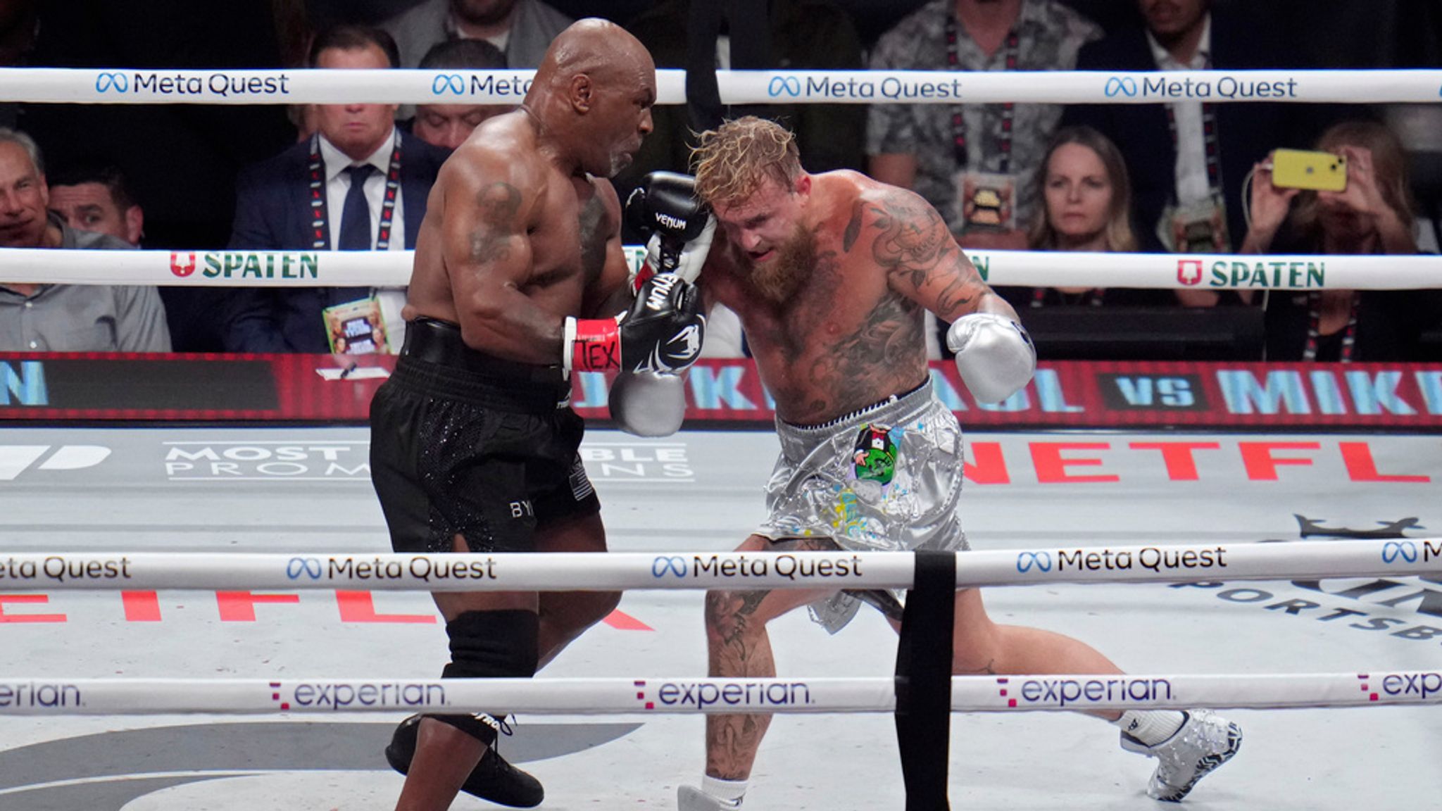 Mike Tyson, left, fights Jake Paul during their heavyweight boxing match, Friday, Nov. 15, 2024, in Arlington, Texas. (AP Photo/Julio Cortez)